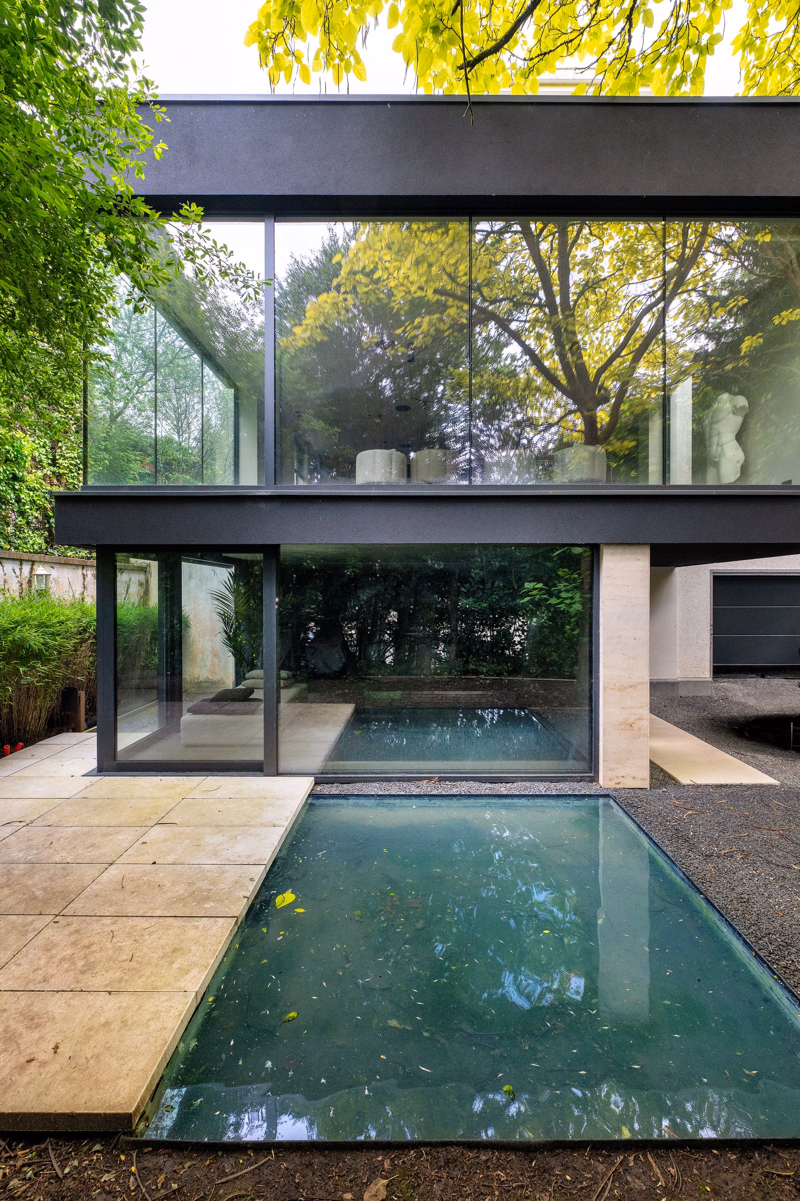 A large house with a swimming pool in front