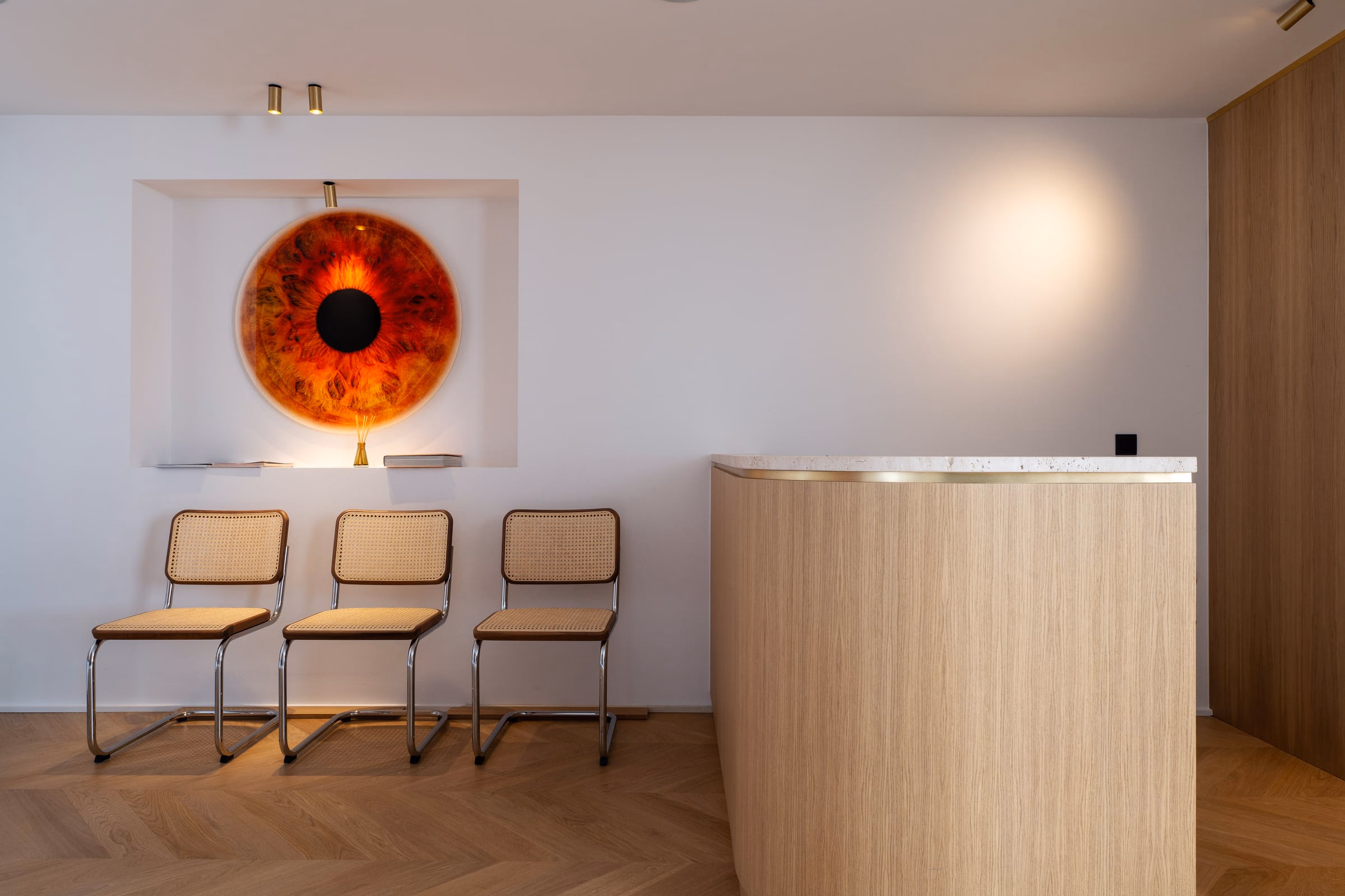 A painting of an eye above a row of chairs
