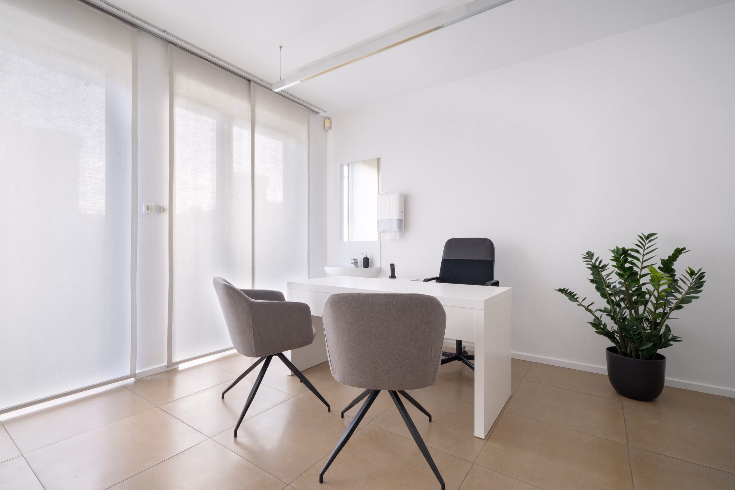 A small office with two chairs and a desk