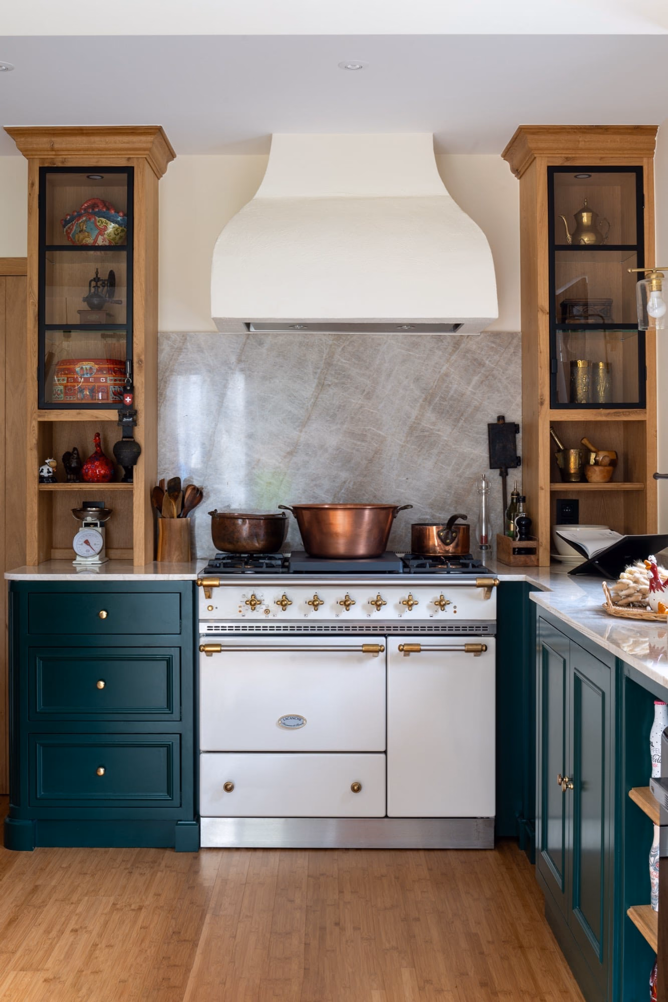 A copper pan on the hob of a custom oak kitchen in English cottage style