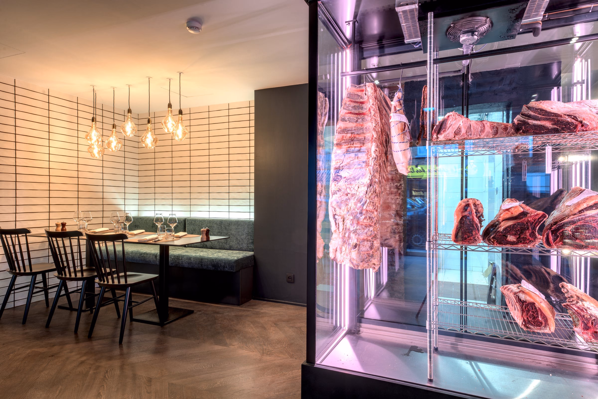 A dining room with tables and a meat display