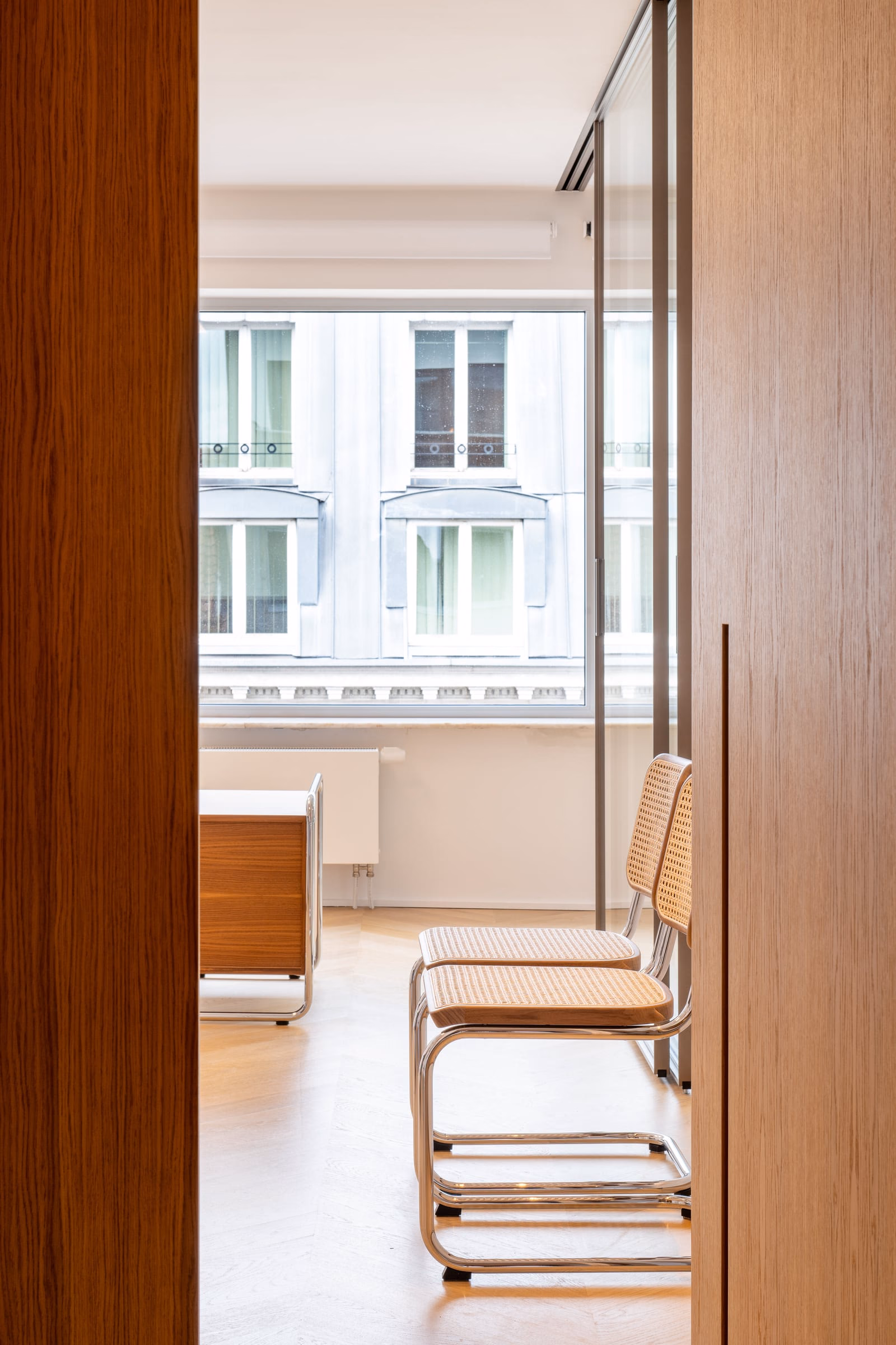 Two chairs in front of a window