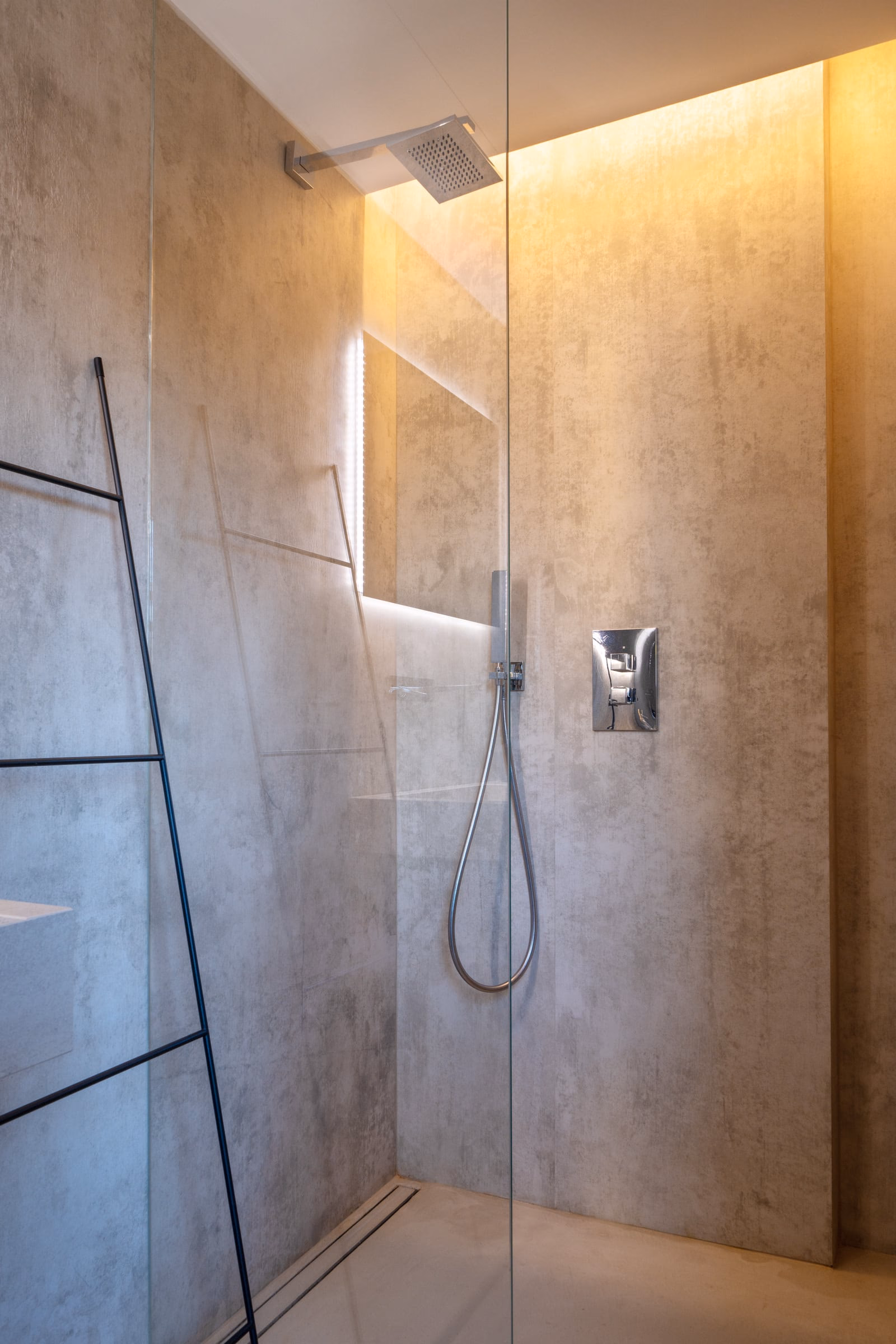 A bathroom with a shower and a wall mirror