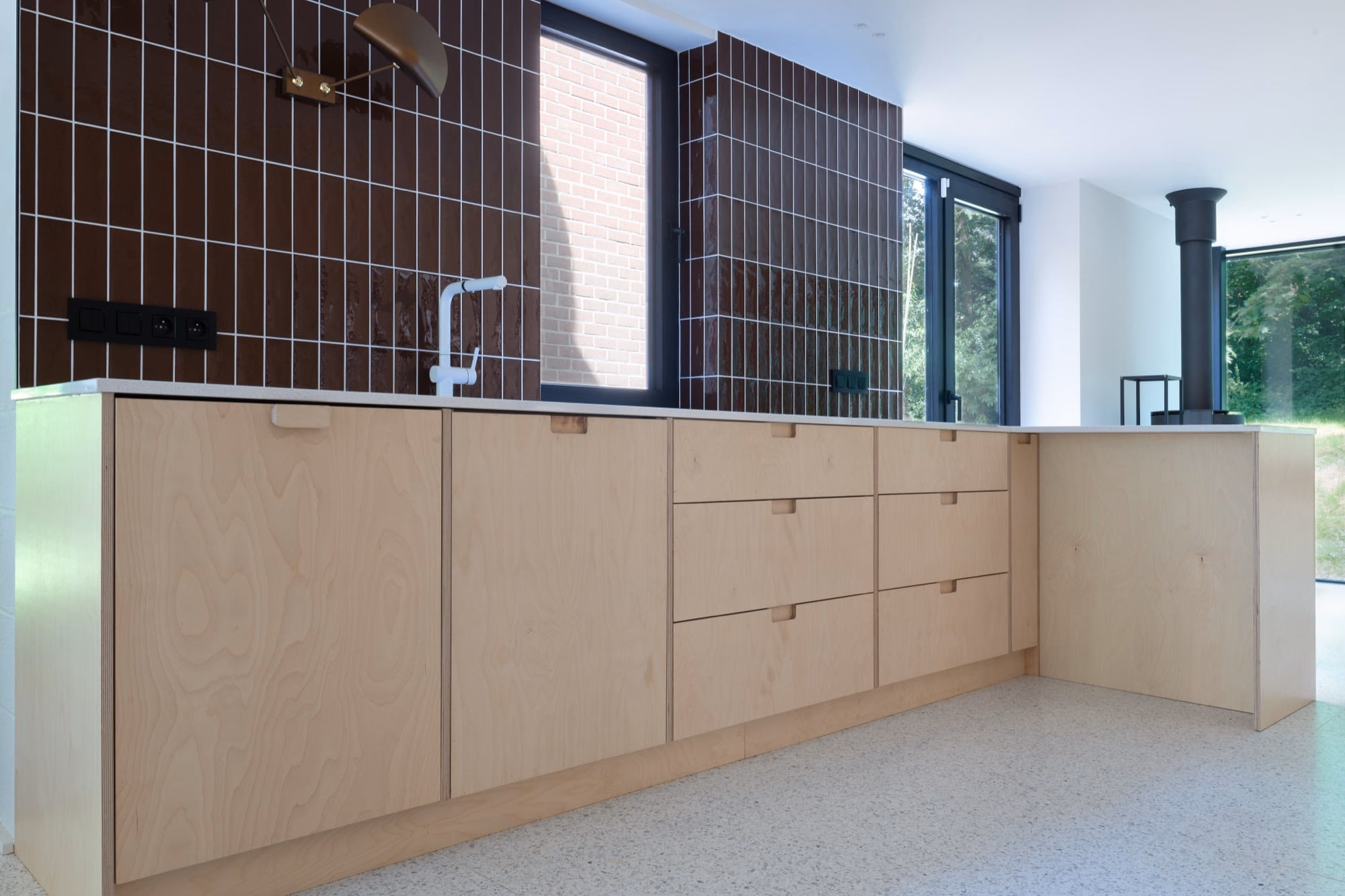 A kitchen with wooden cabinets and a window