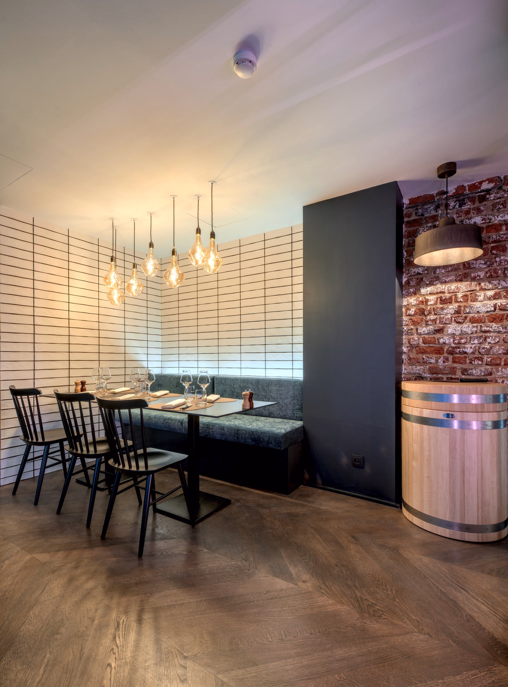 A dining room with tables, chairs and a wooden barrel