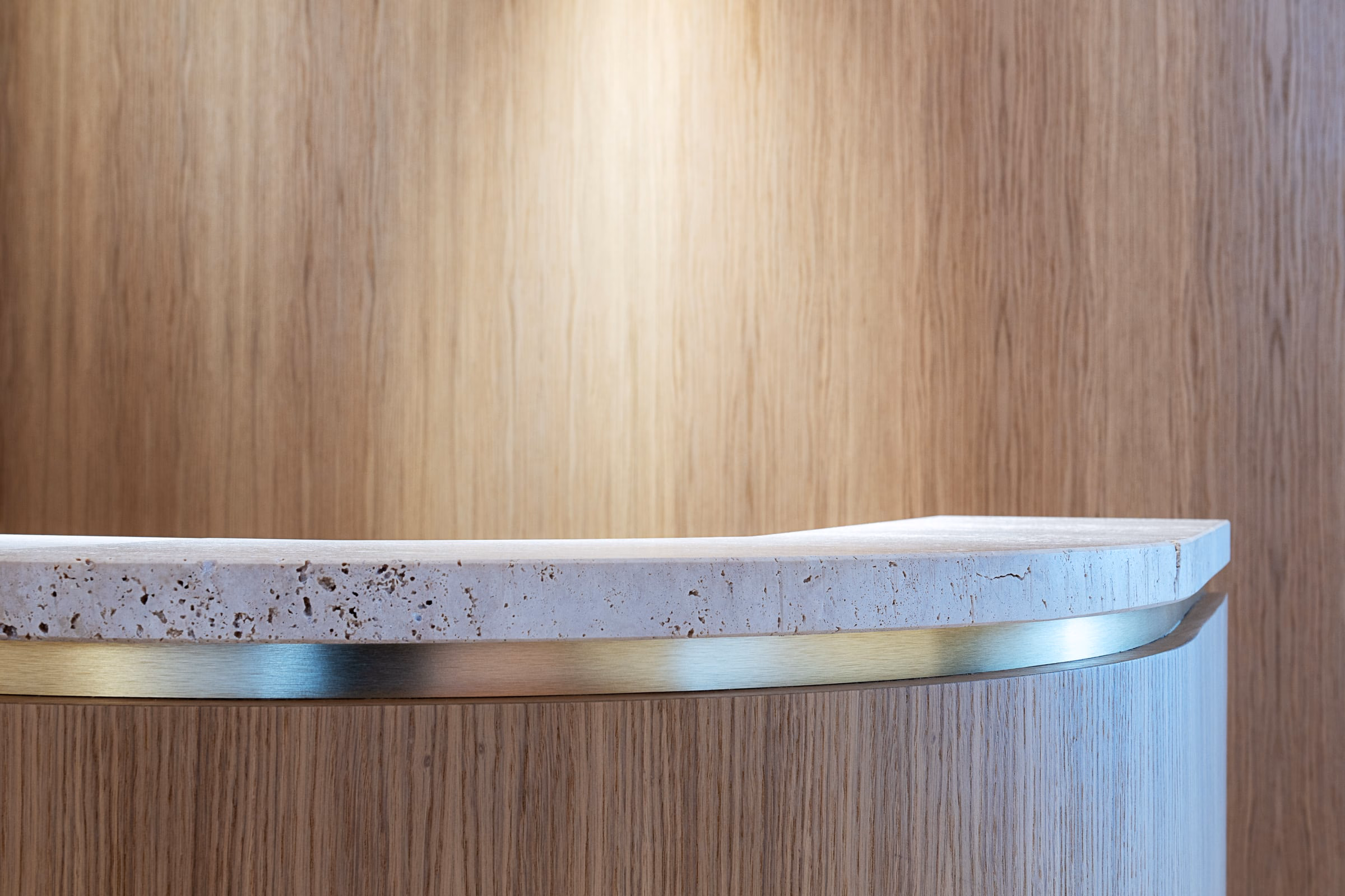 A counter with a wooden wall behind it