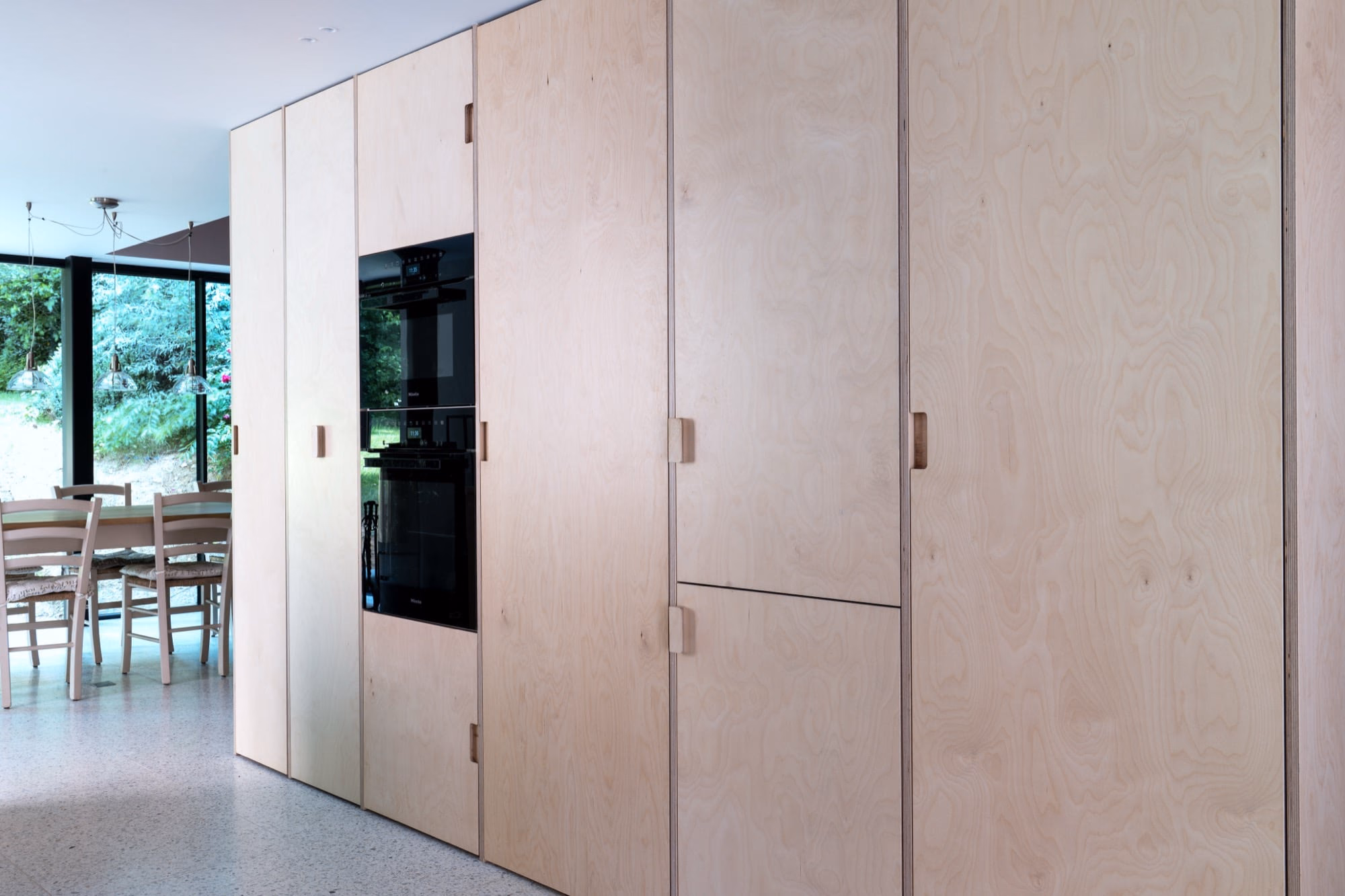 A kitchen with wooden cabinets and a black oven