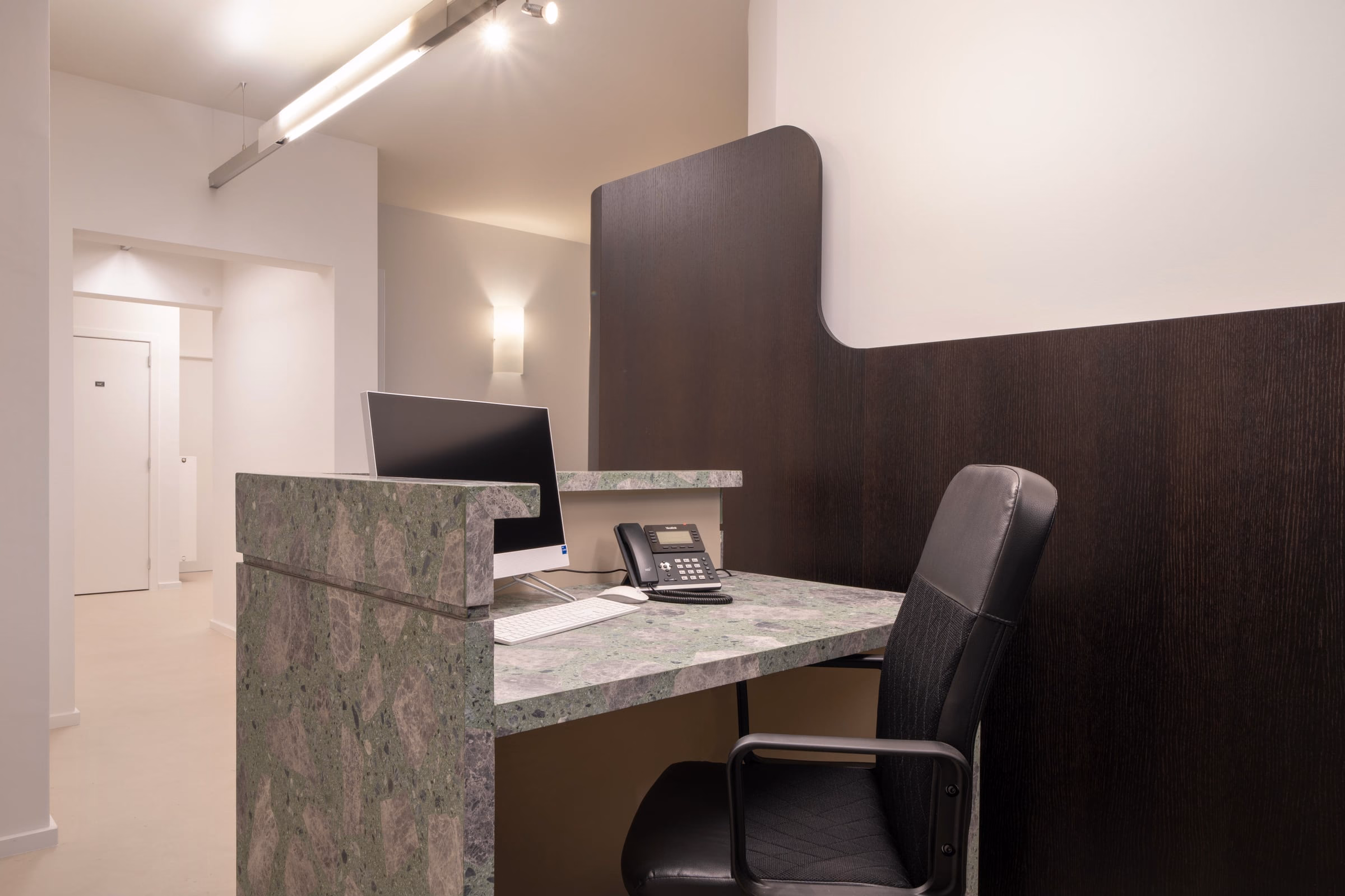 A desk with a computer and a telephone