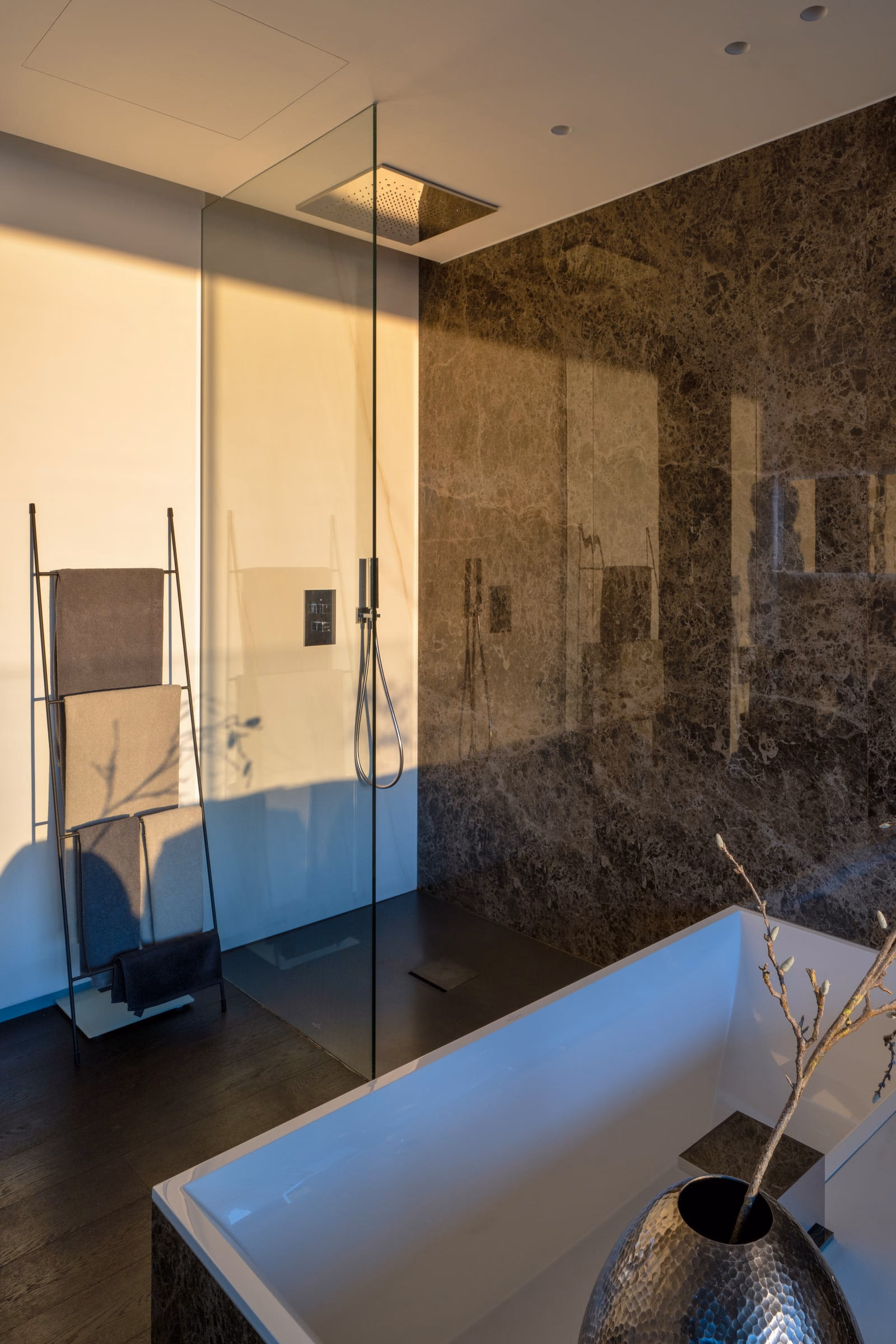 A bathroom with a towel rail and a bathtub