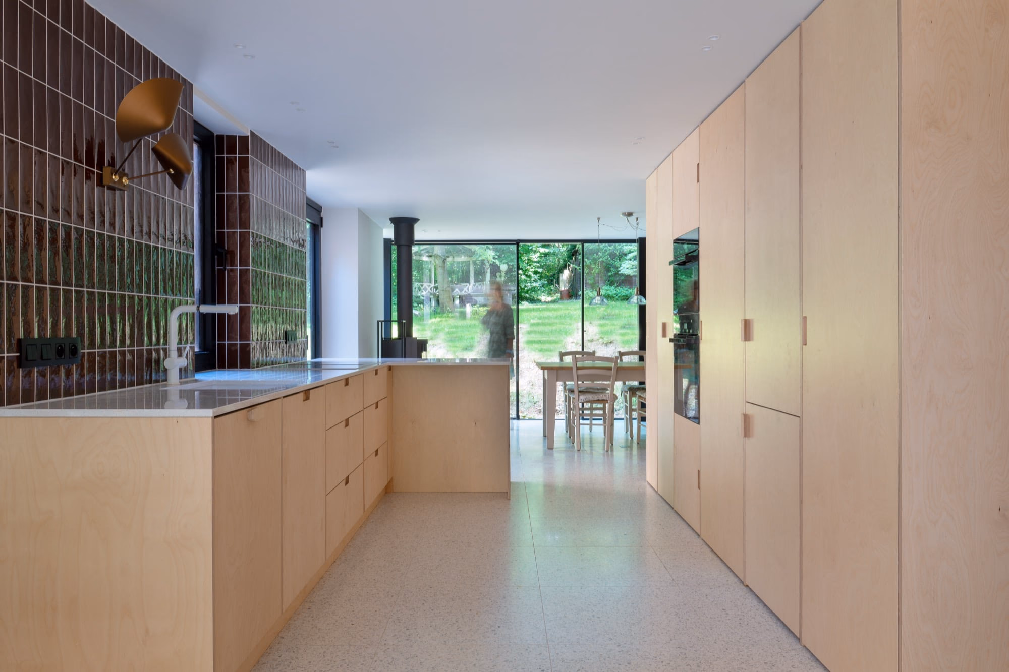 A kitchen with wooden cabinets and a stainless steel worktop