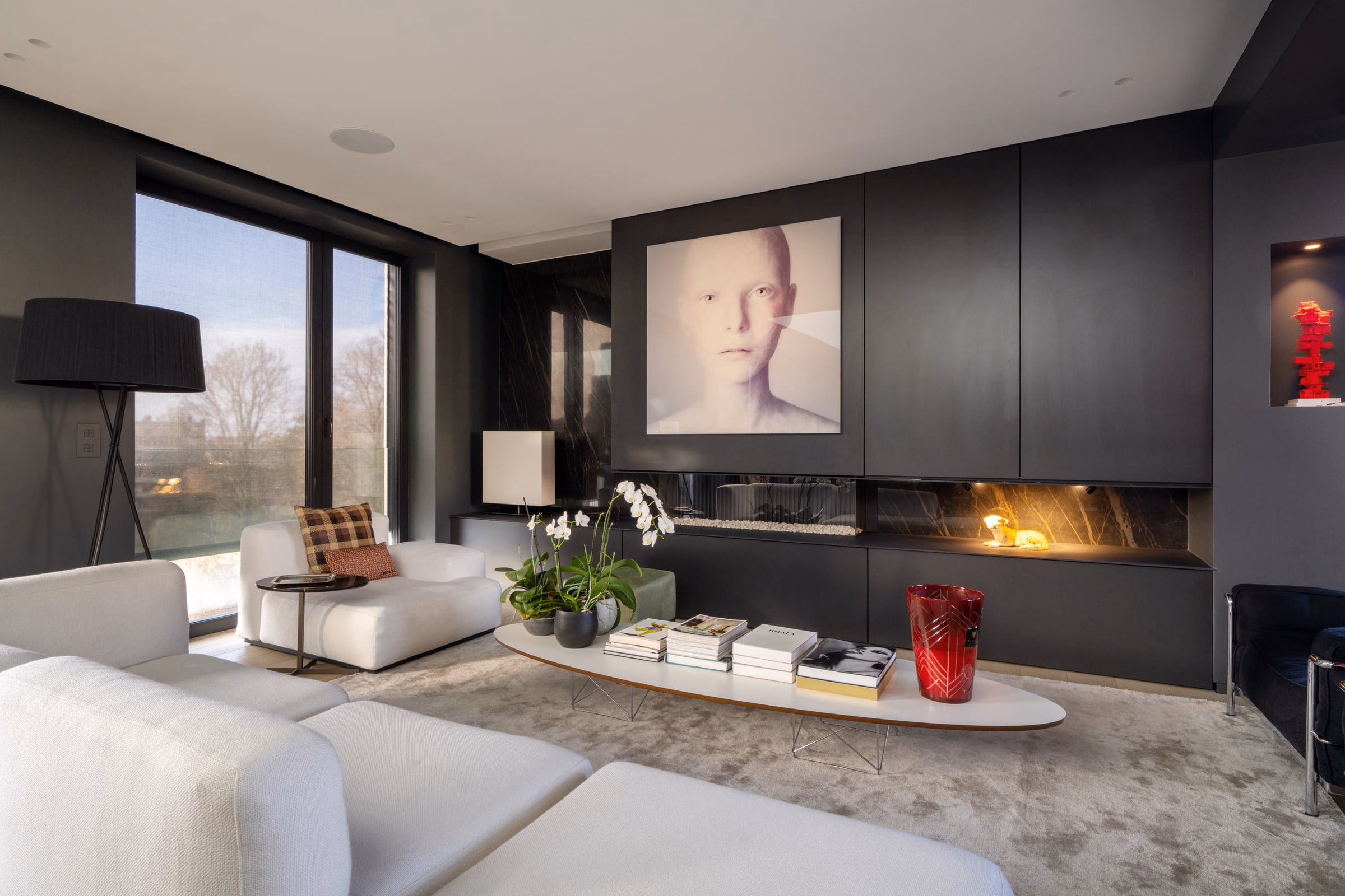 A living room with a portrait painting on the wall