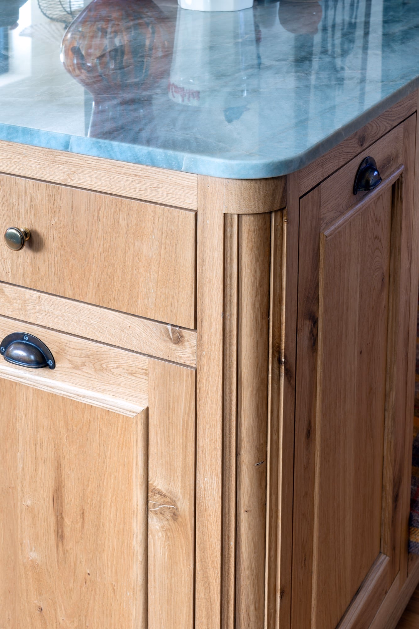 A wooden chest of drawers with a marble top