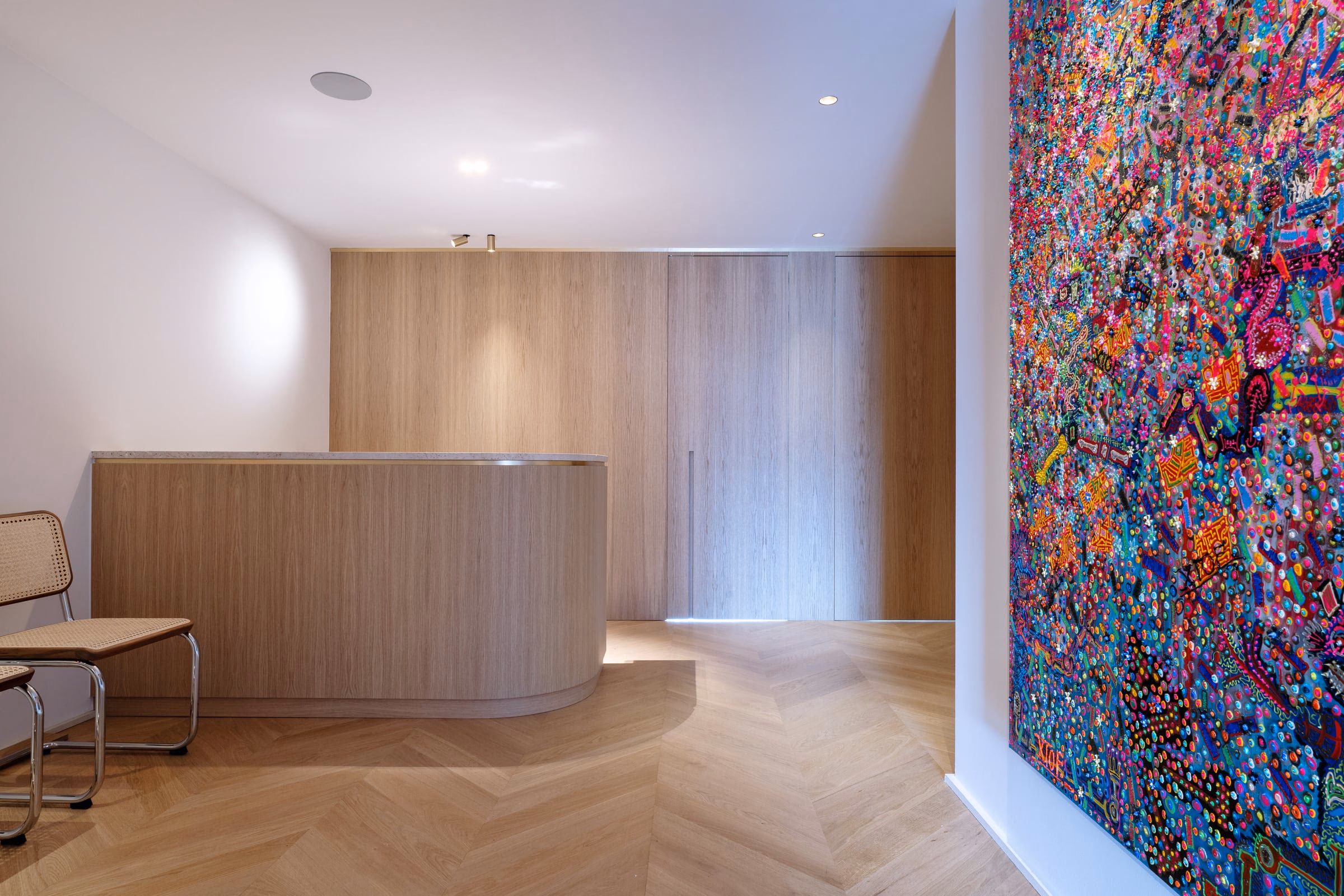 A colourful painting beside a wooden counter
