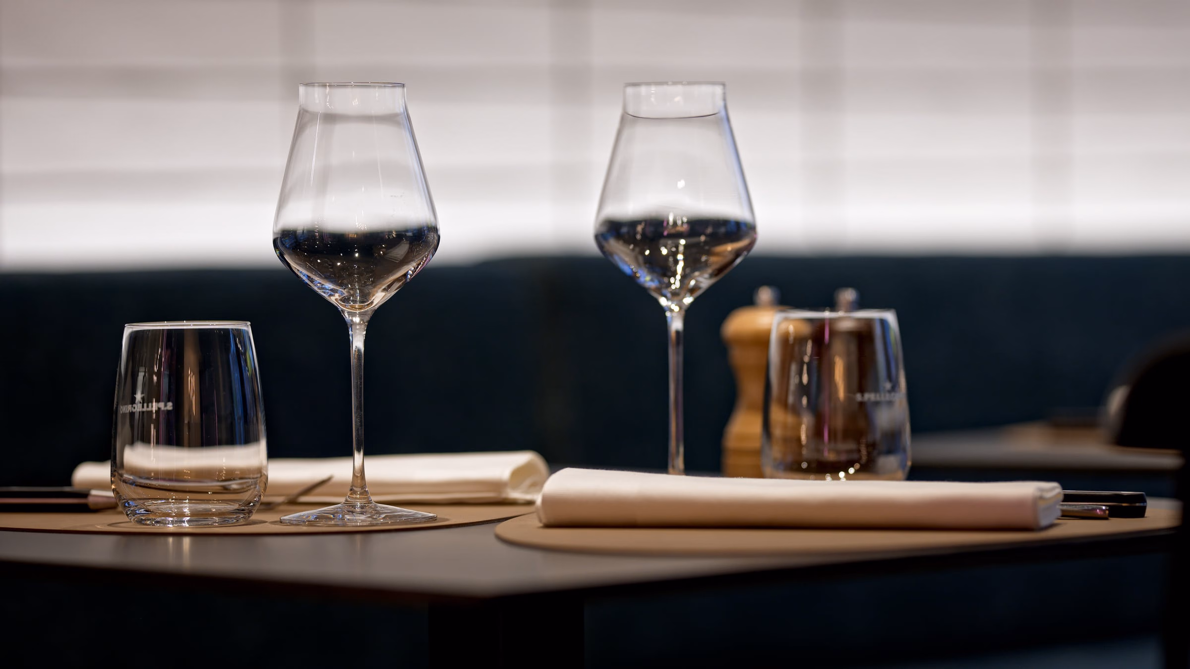 Two empty wine glasses and a napkin on a table