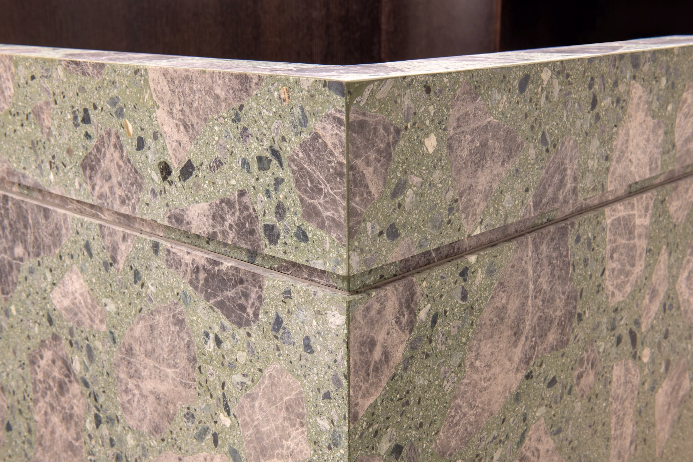 A corner of a green and grey marble counter