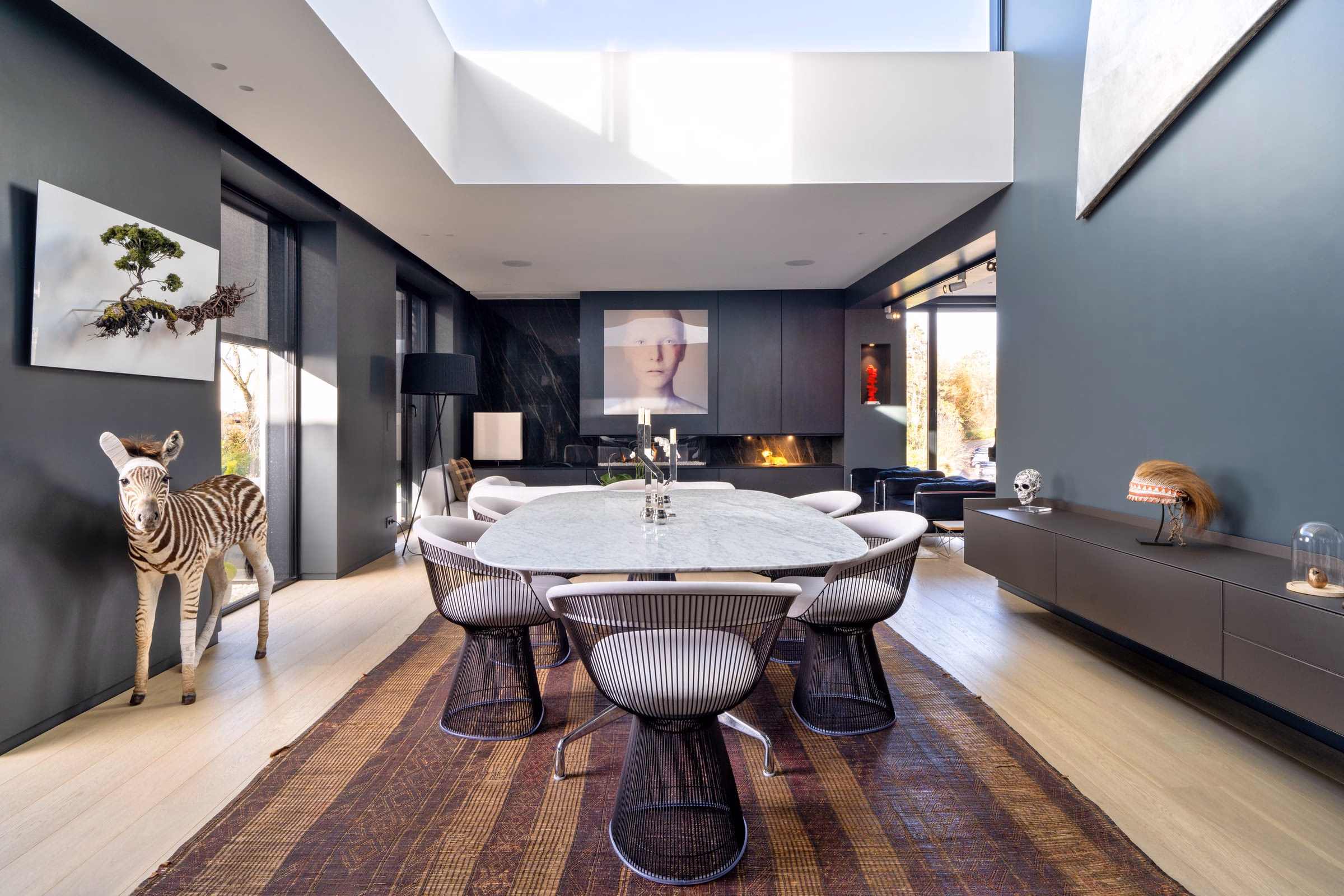 A dining room with a marble table and chairs