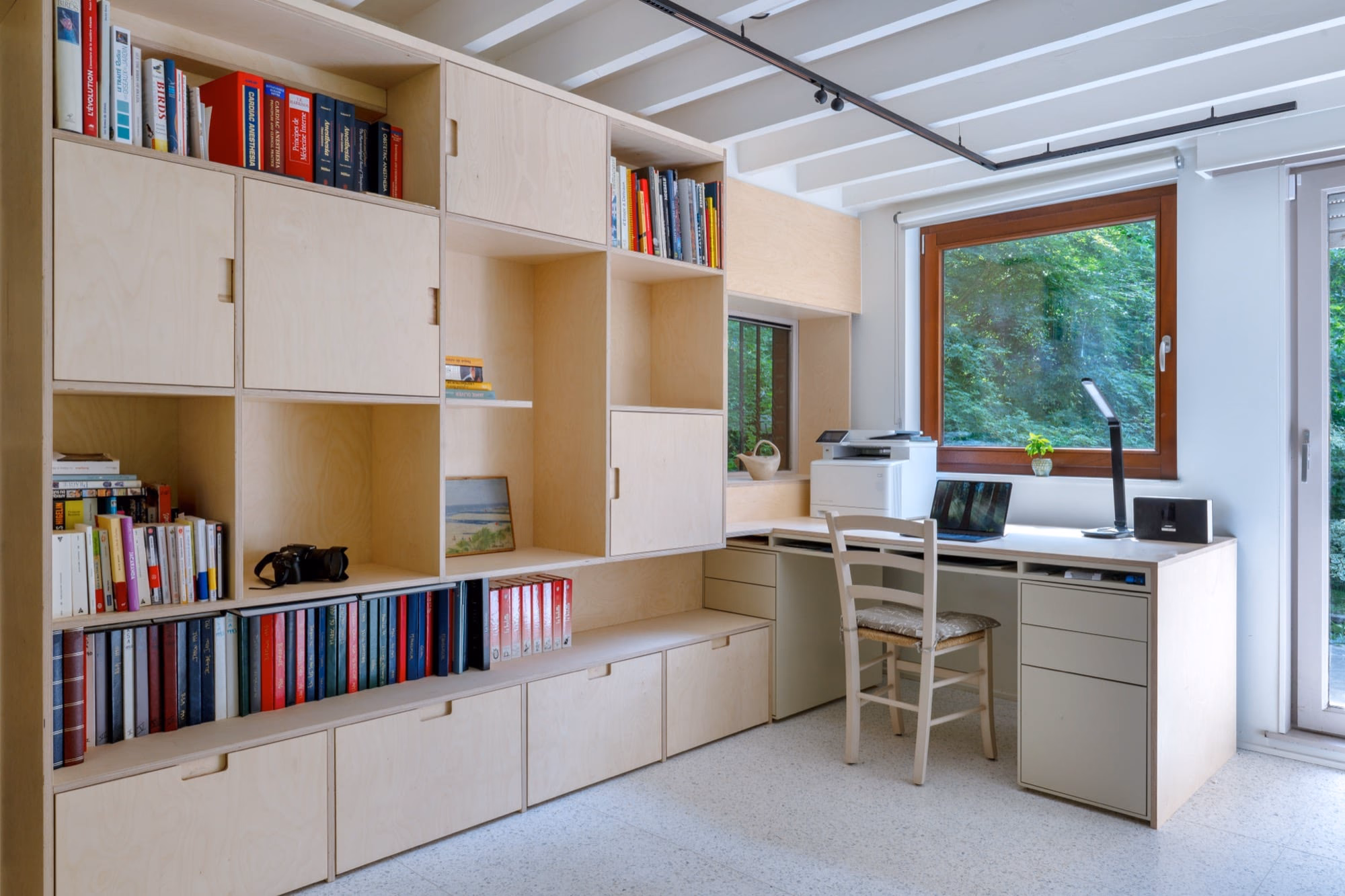 A bookshelf with a dictionary on top