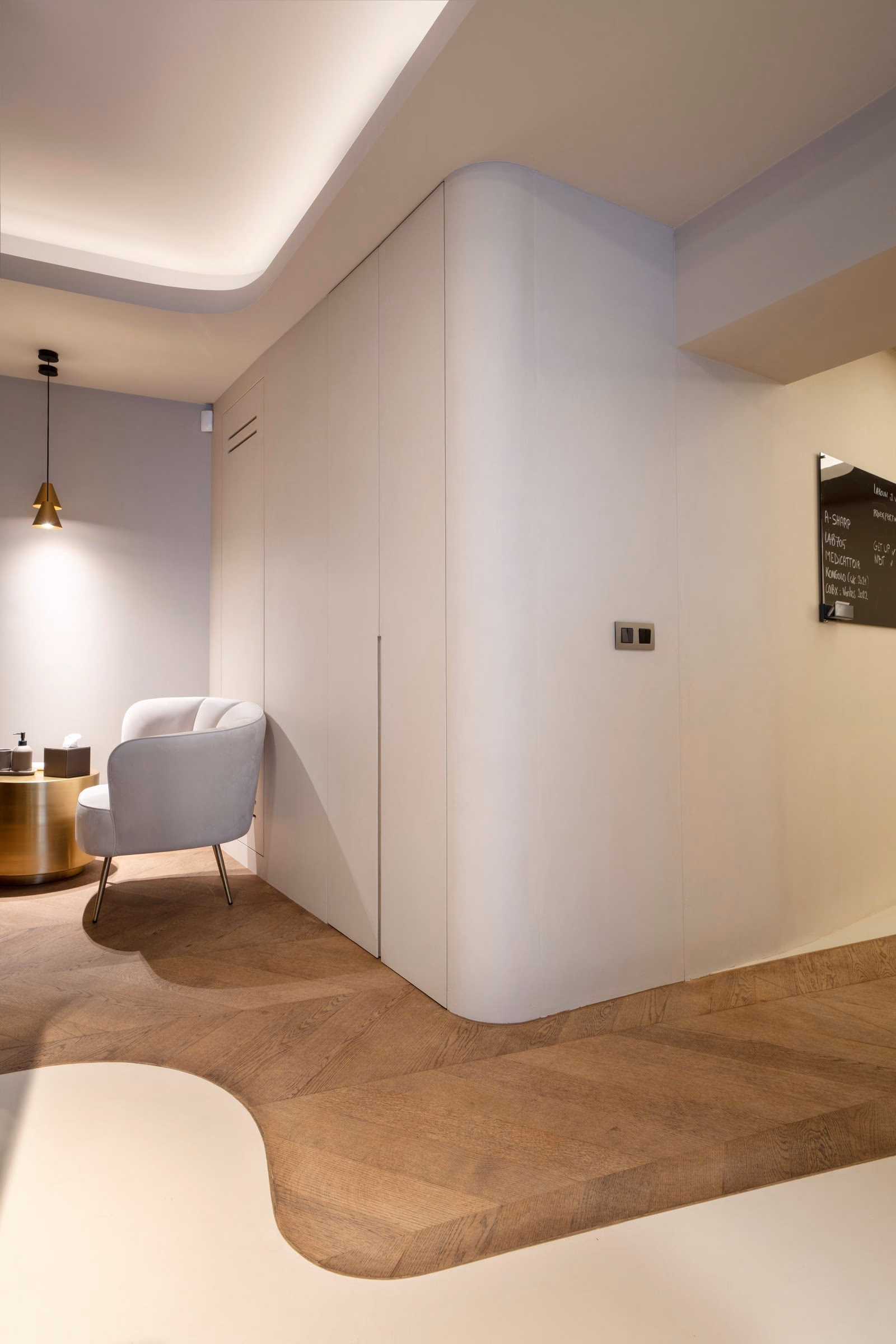 A corner of a room with a chair and a sign on the wall