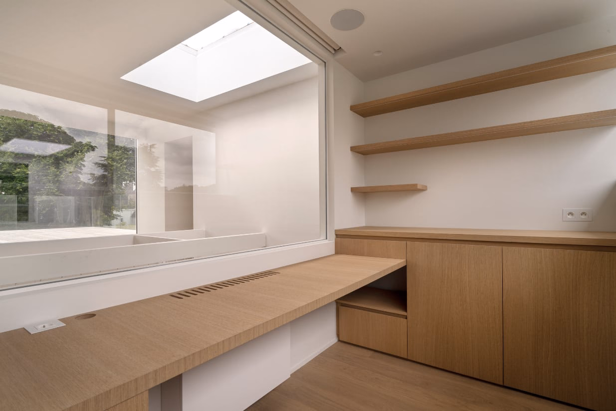 A room with a large window and a wooden desk