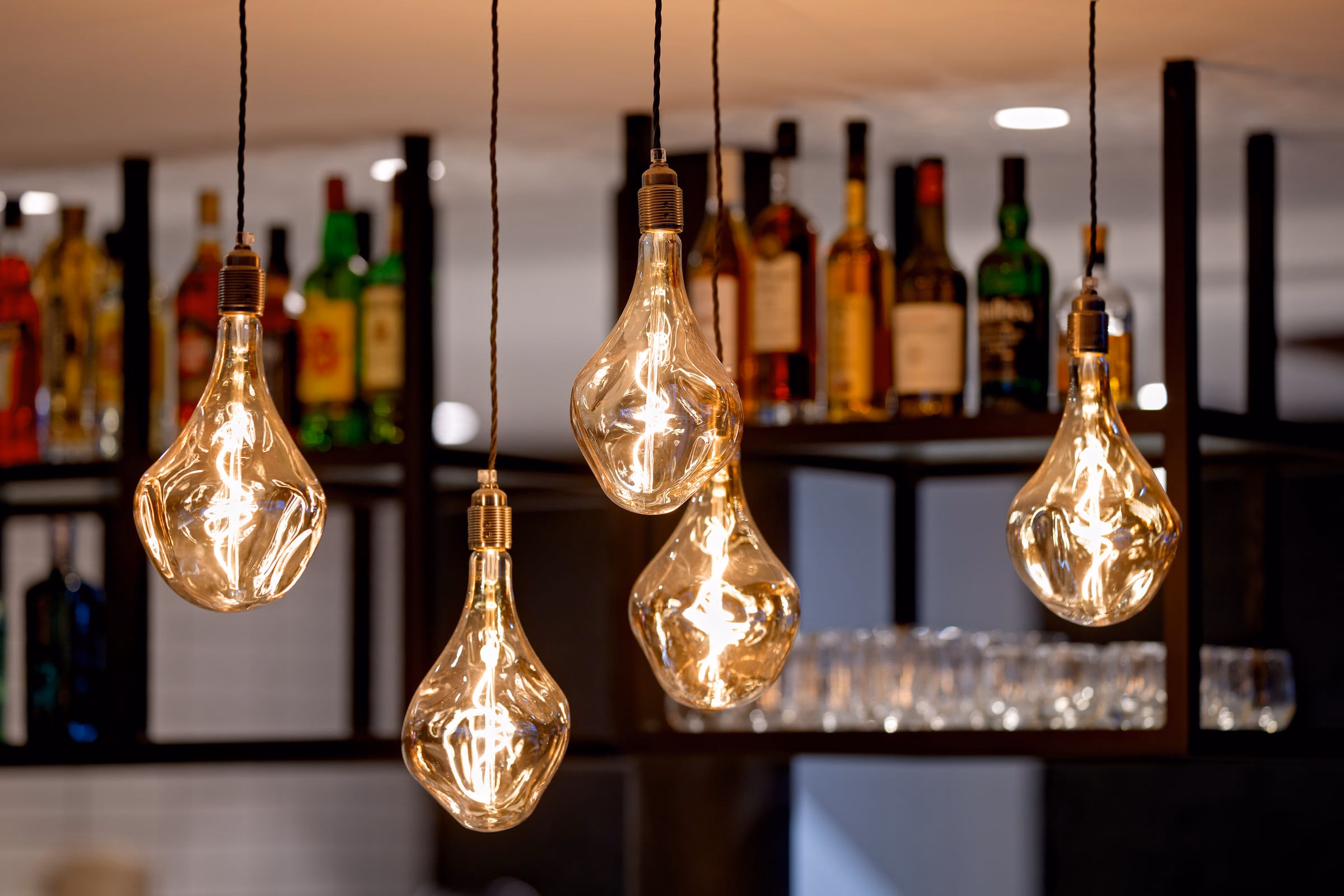 A cluster of bare bulbs hanging from the ceiling