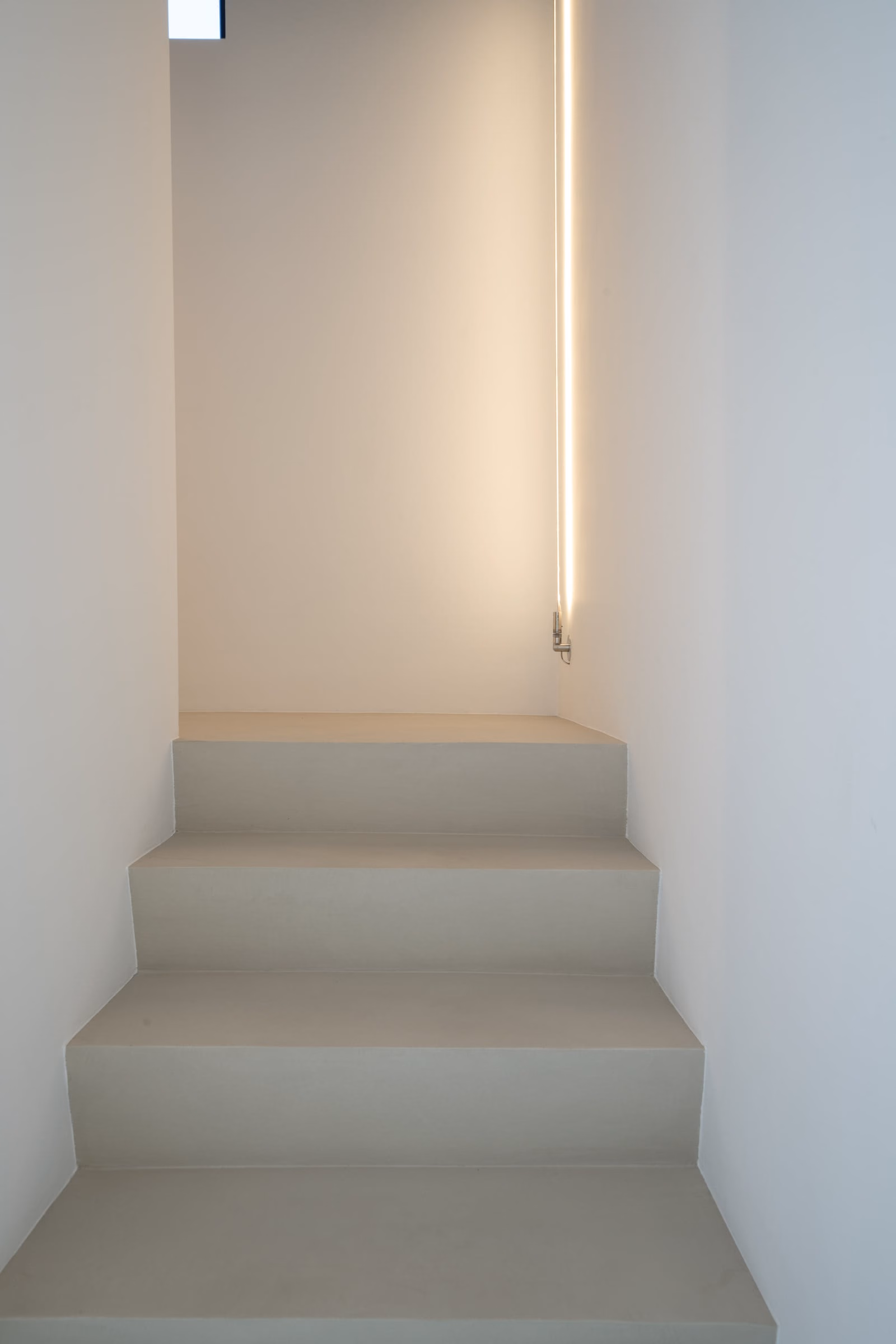A flight of stairs with a wall light