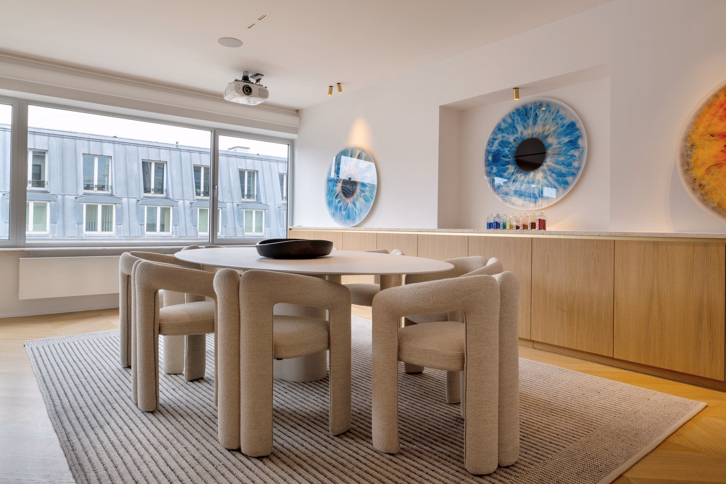 A dining room with a round table and chairs