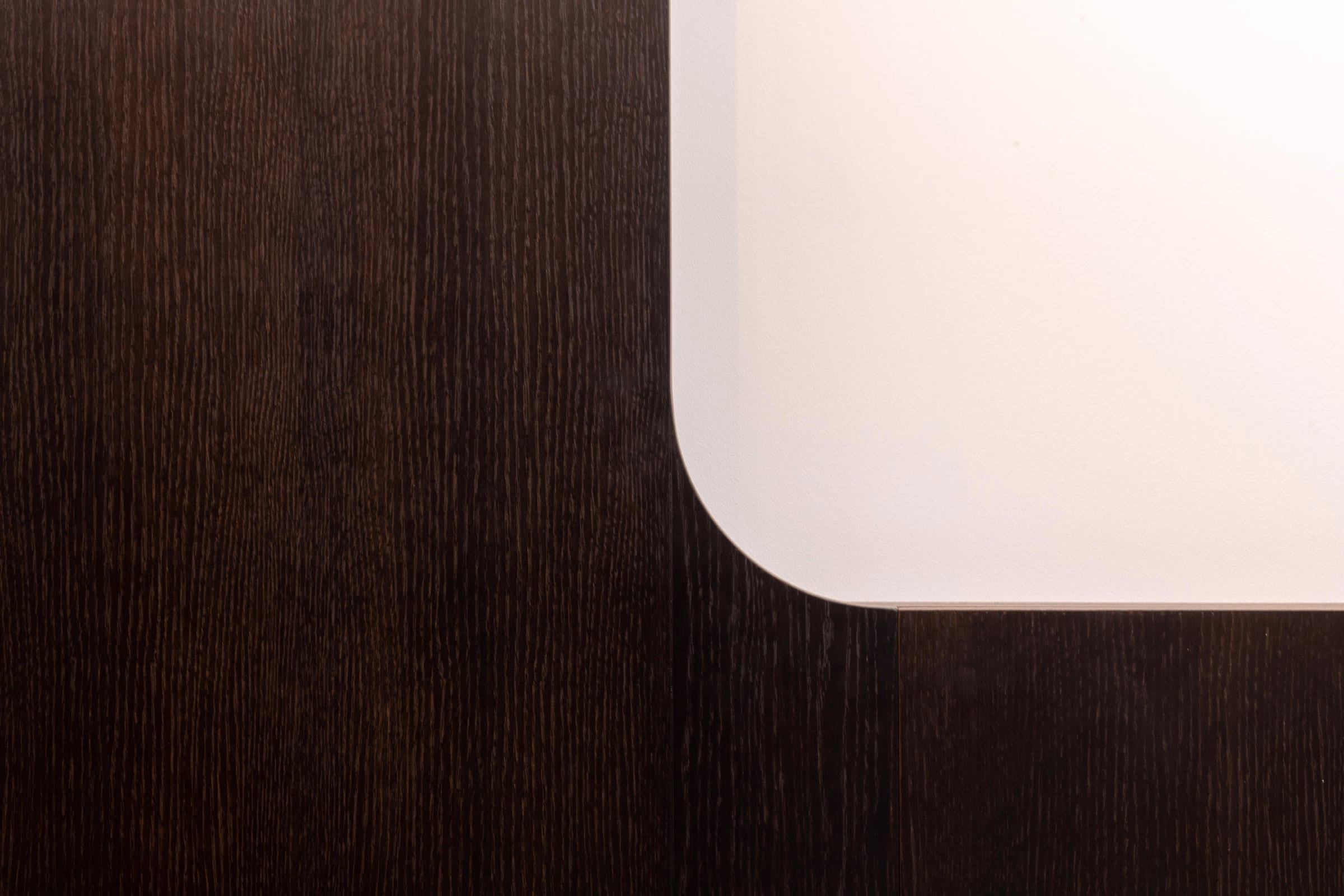 Detail of a wooden surface with a white corner