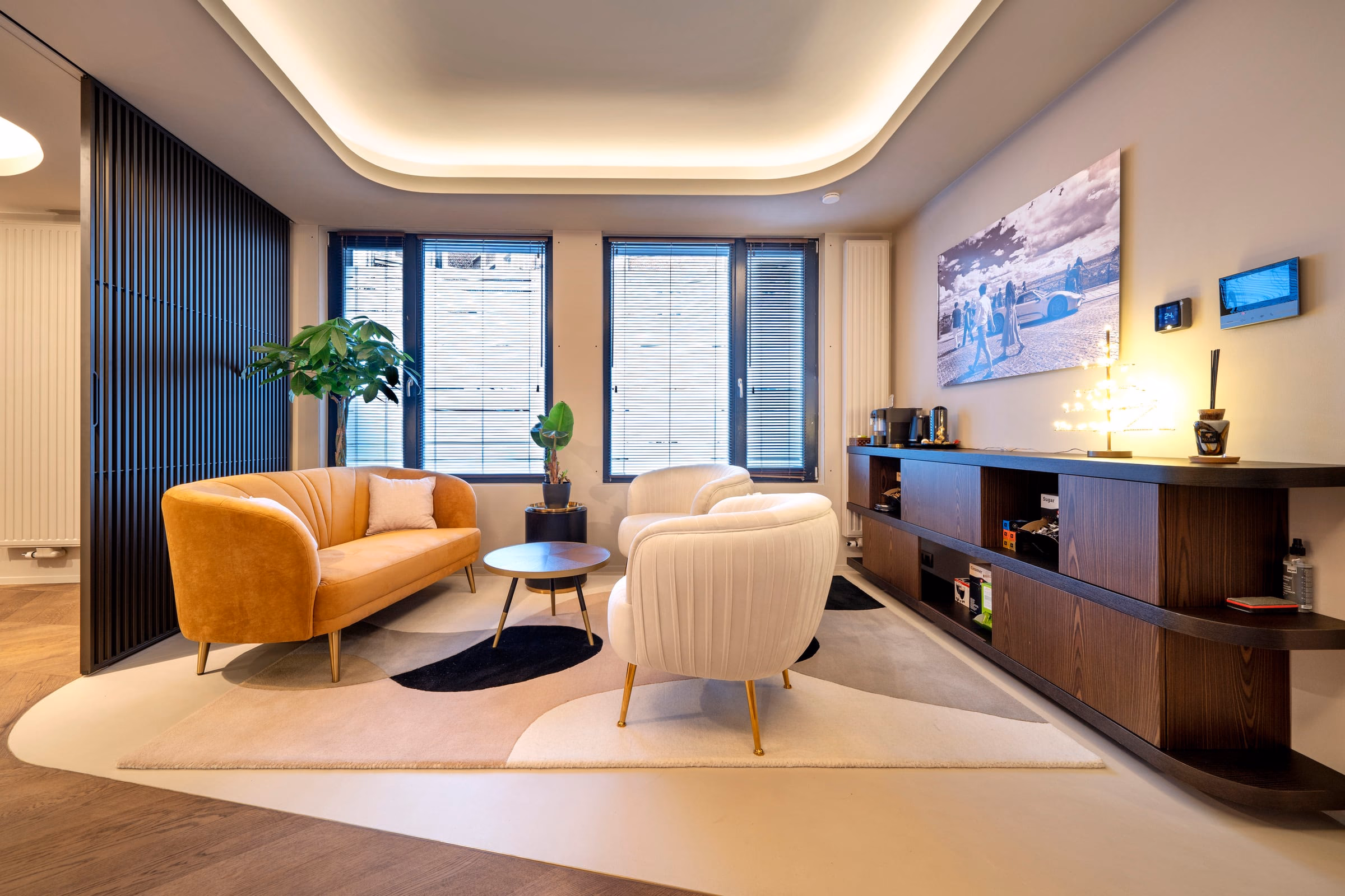 A living room with a sofa and two armchairs