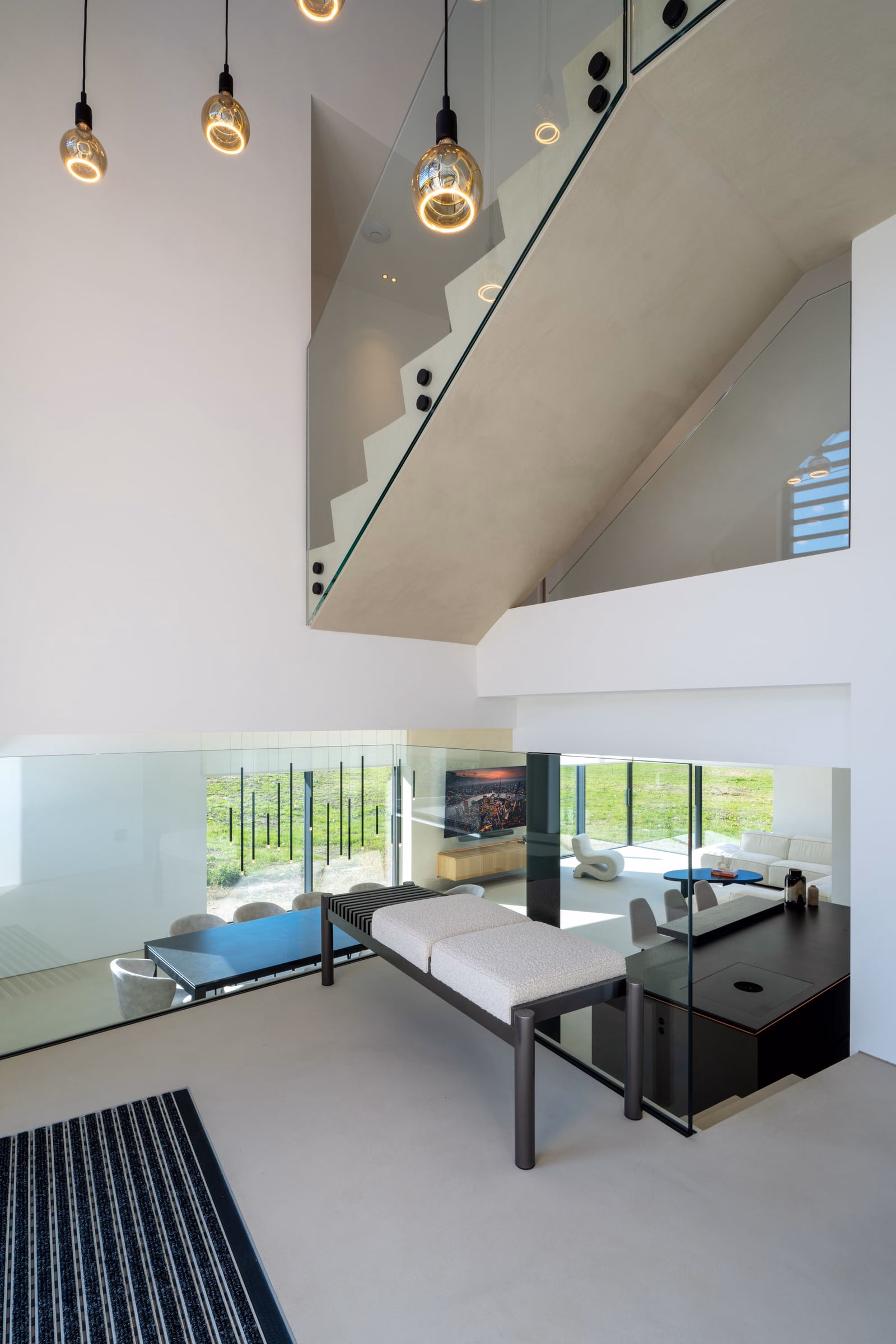 A living room with a staircase up to the first floor
