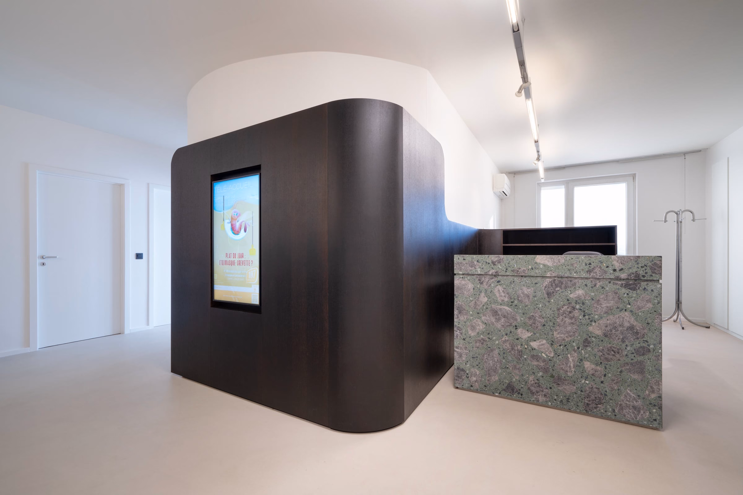 A screen on a wall in a waiting area