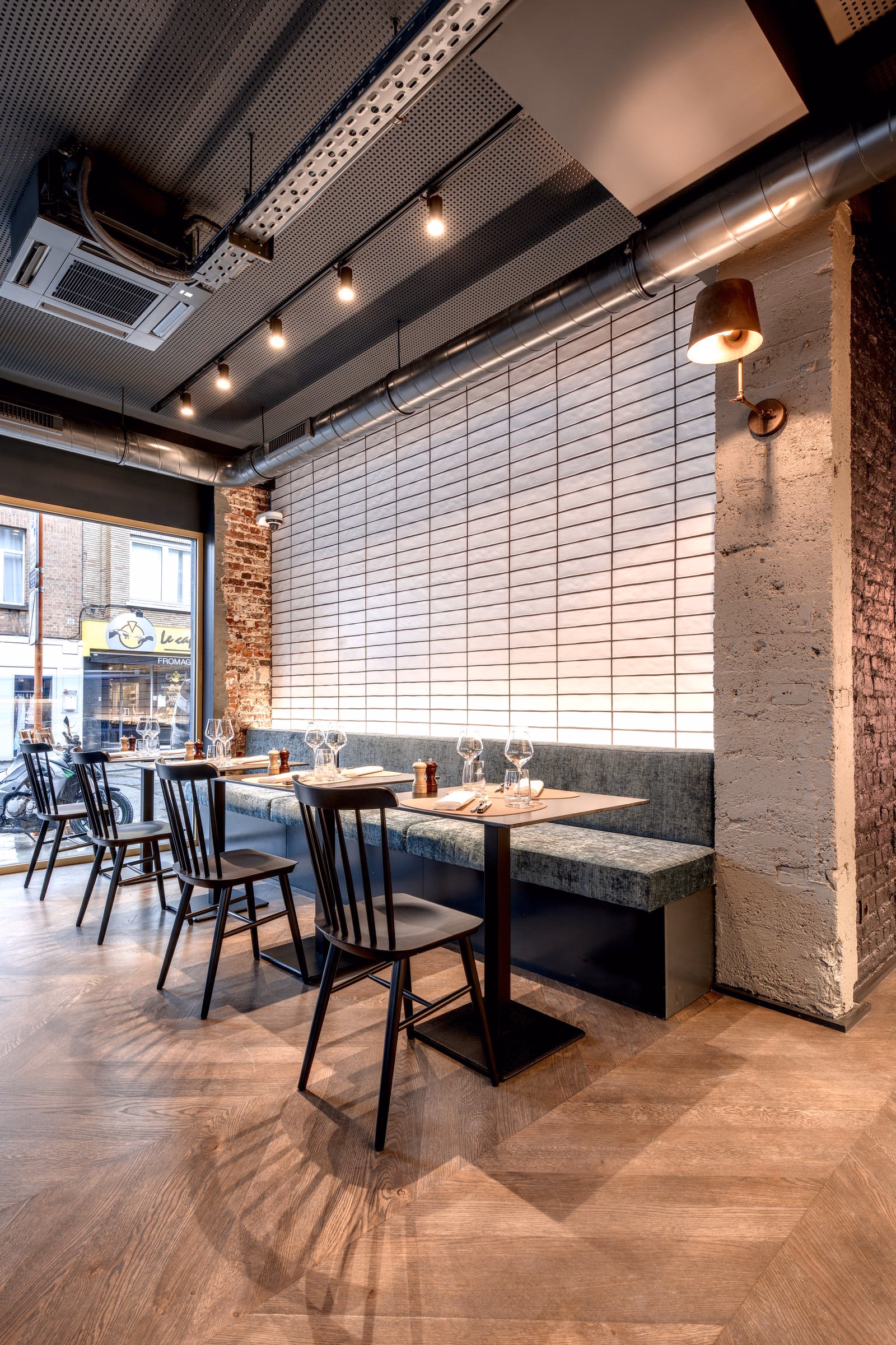 A restaurant with tables, chairs and a yellow sign