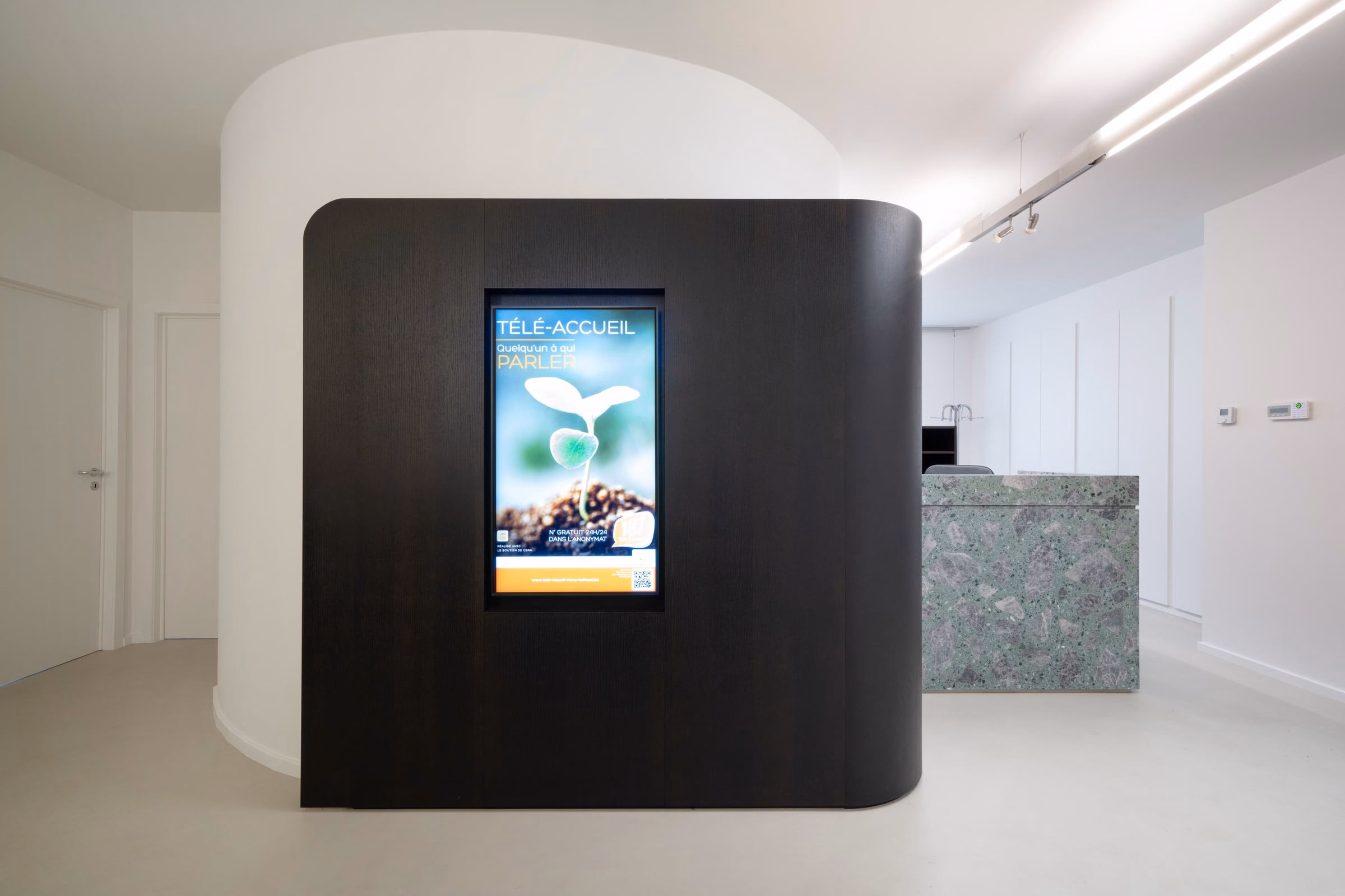 A screen on a wall in a reception area