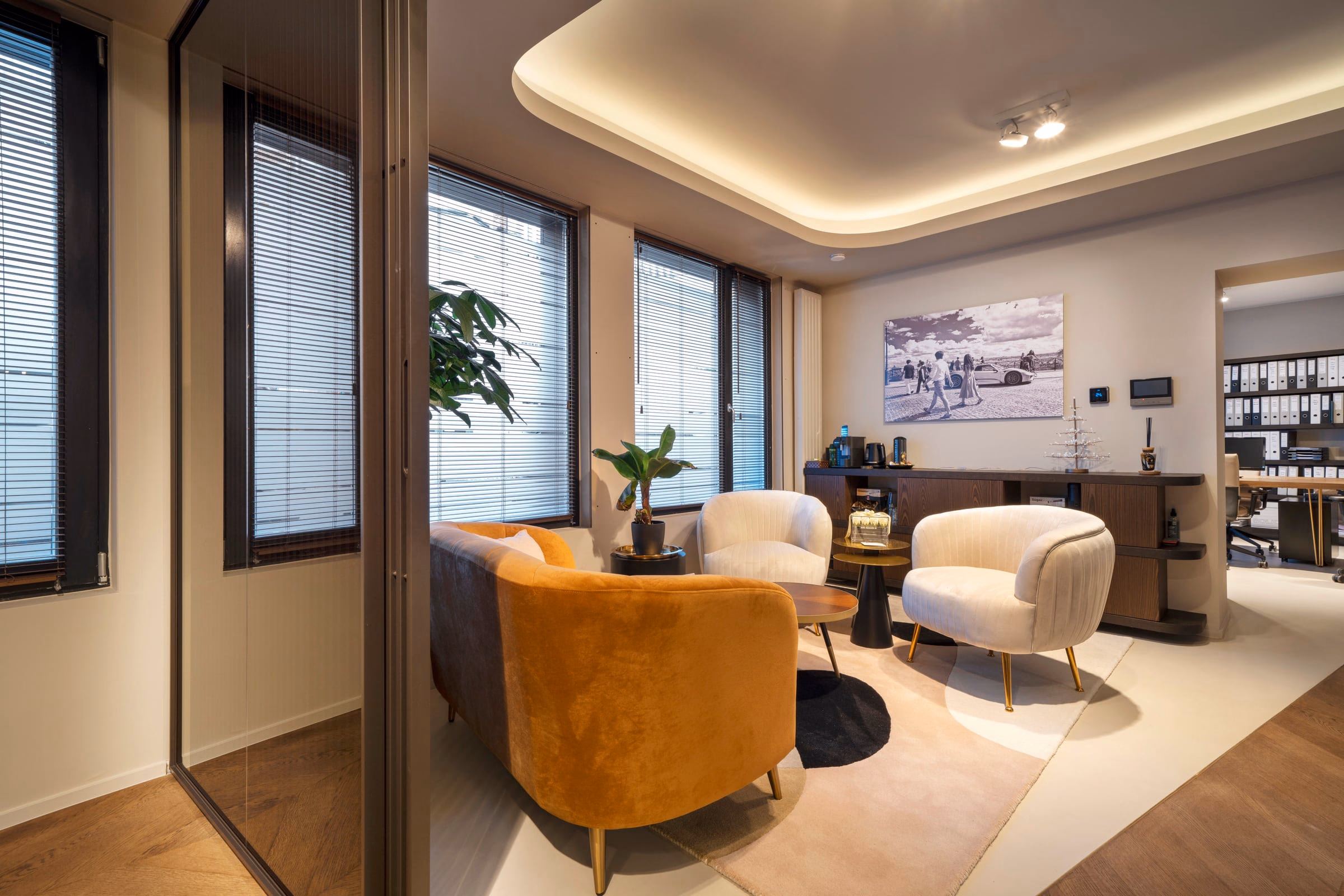 A living room with a sofa and two armchairs