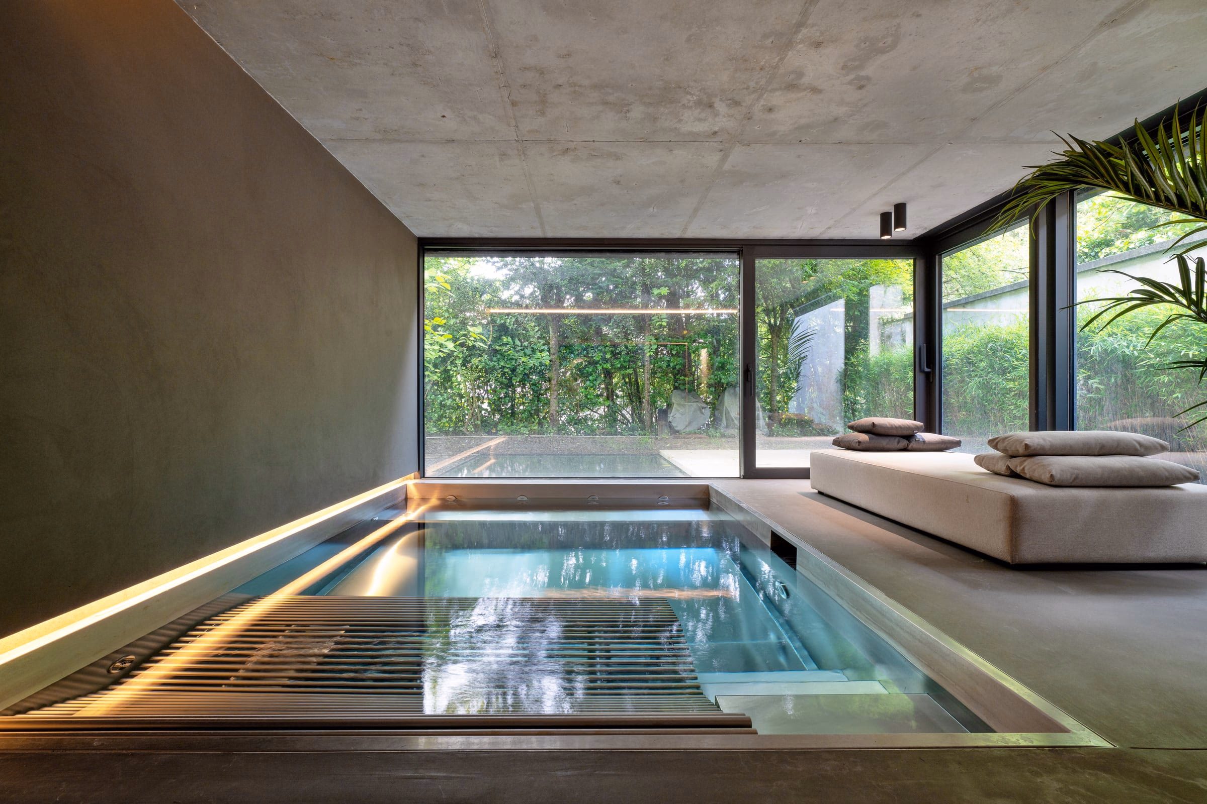 An indoor swimming pool with a sliding glass door