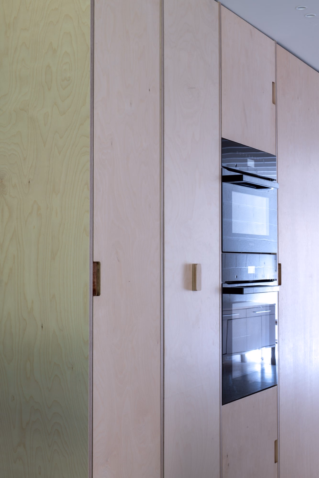 A kitchen with stainless steel appliances and wooden cabinets