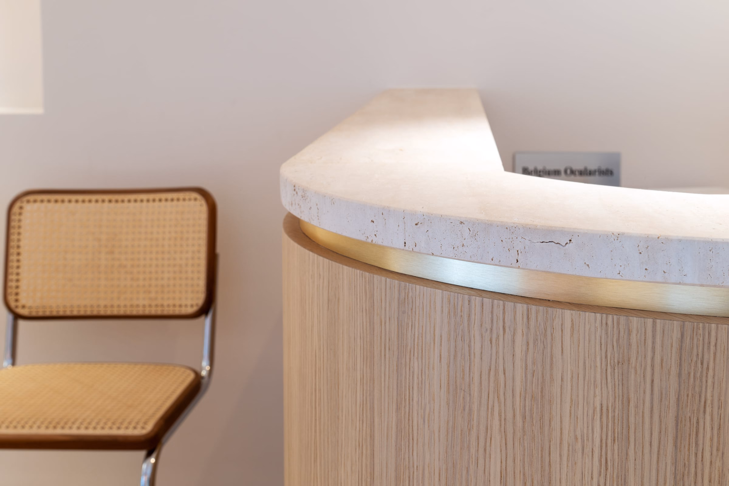 A wicker chair before a reception counter