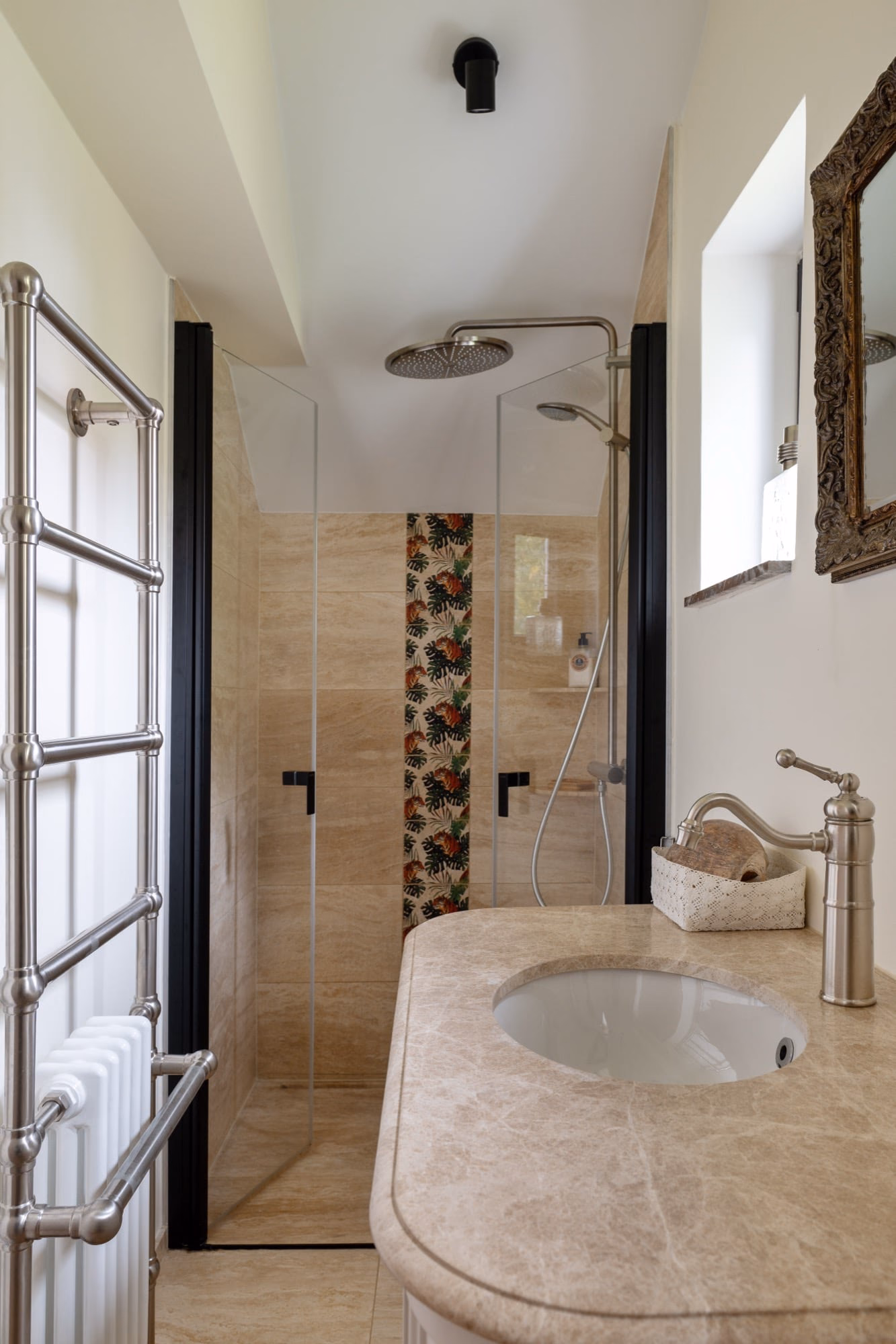 A bathroom with a washbasin and a walk-in shower