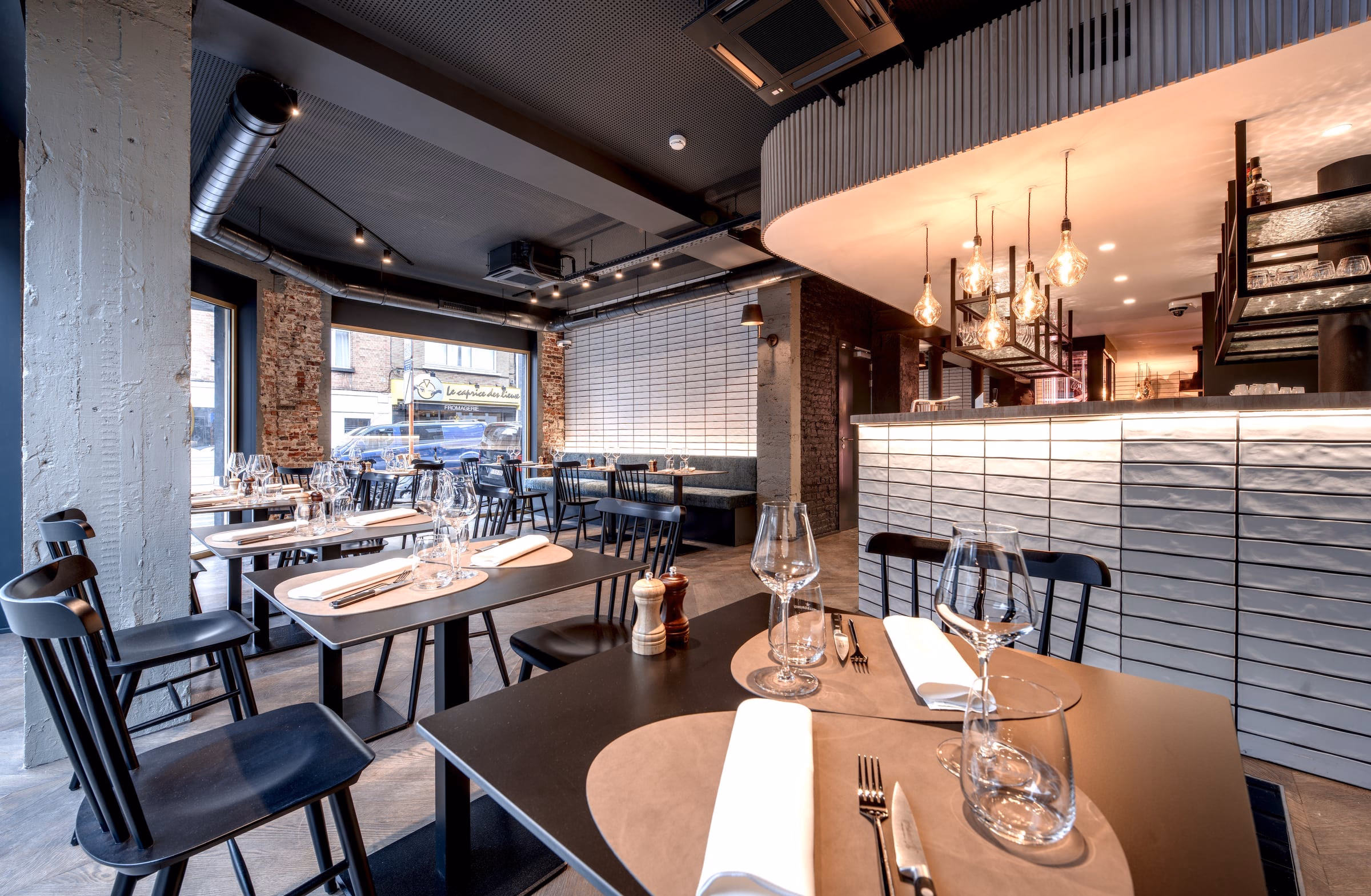 A restaurant dining room with a sign on the wall