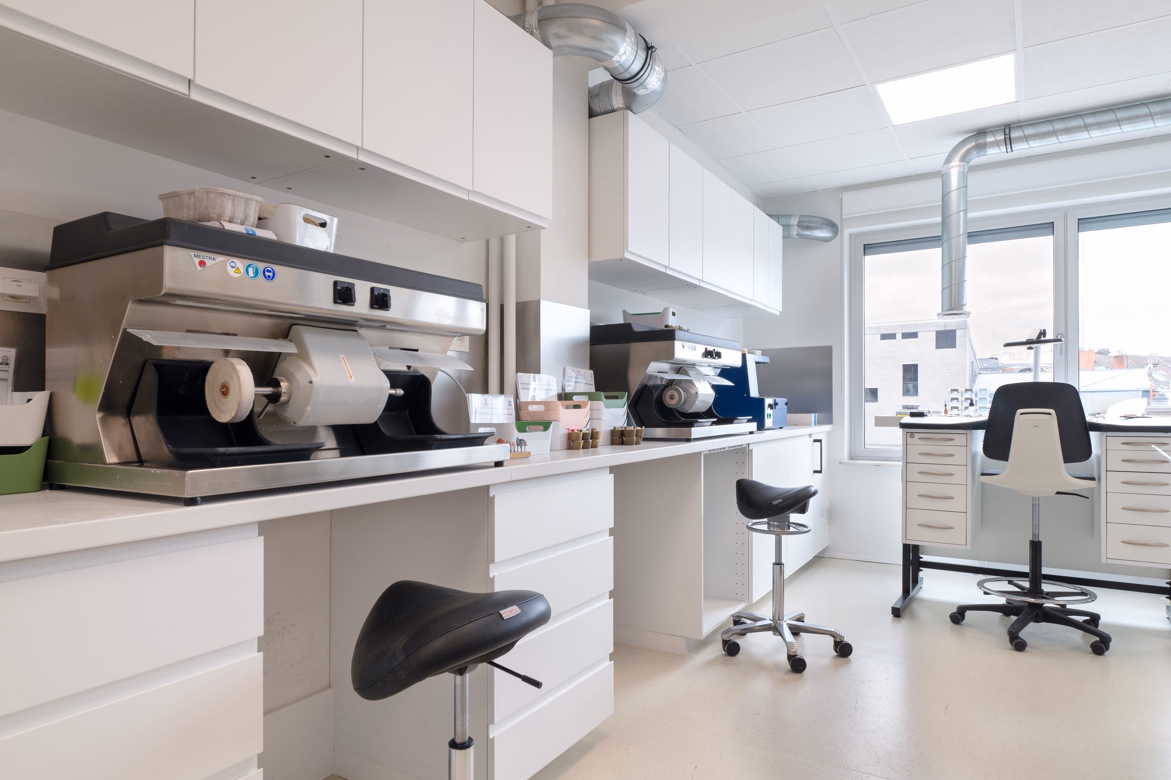 A black stool in front of a laboratory machine