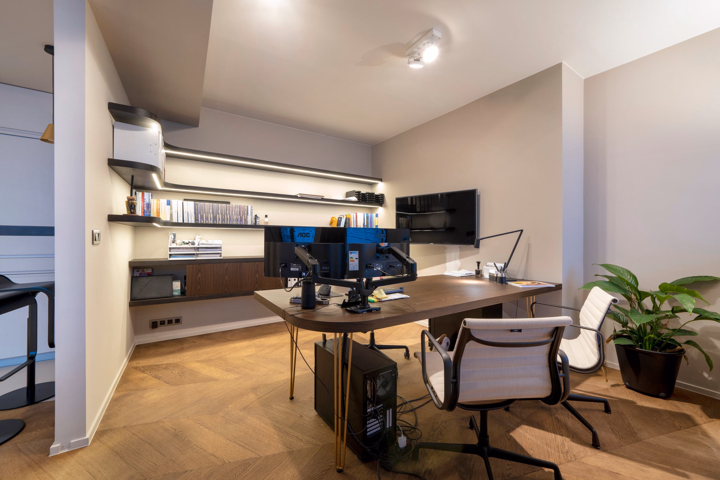 Two monitors on a desk in a home office