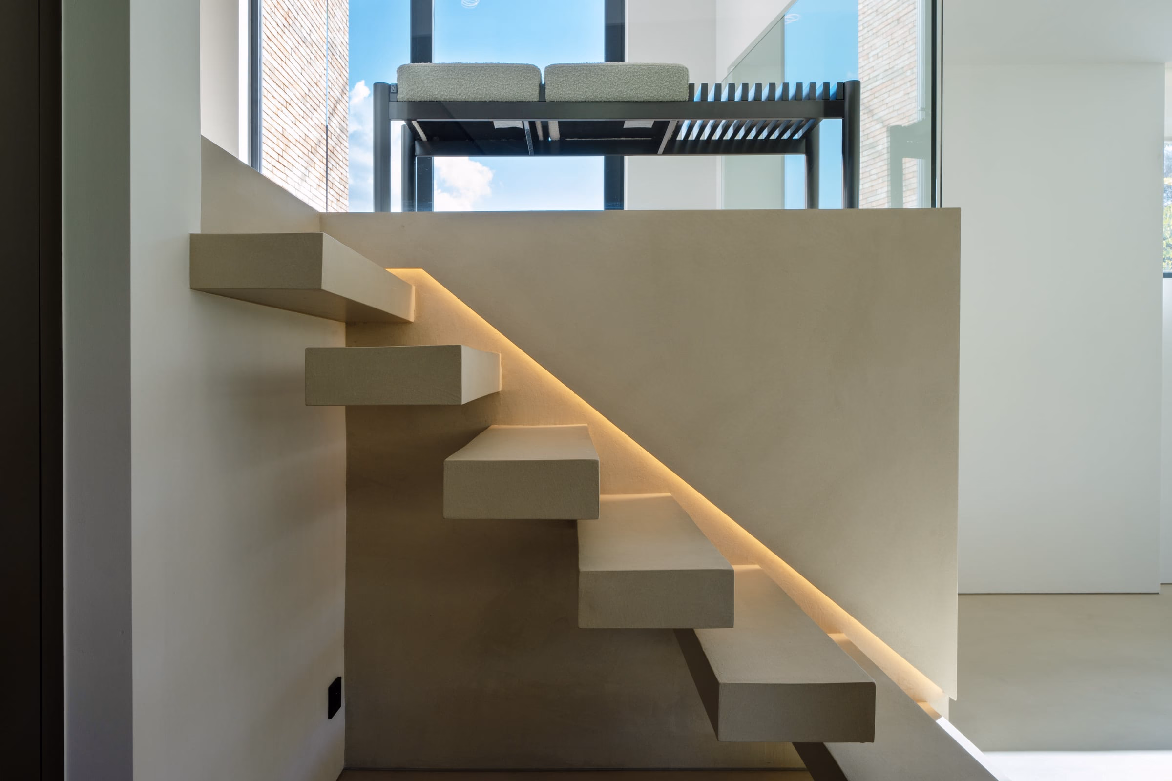 A staircase with a bench at the top