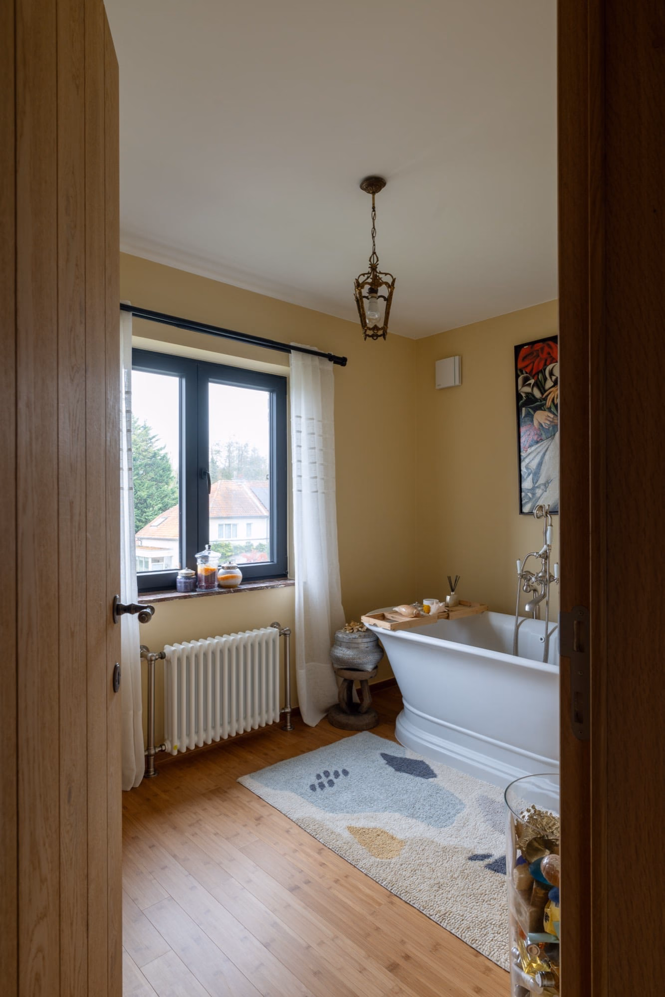 A bathroom with a bathtub and a window