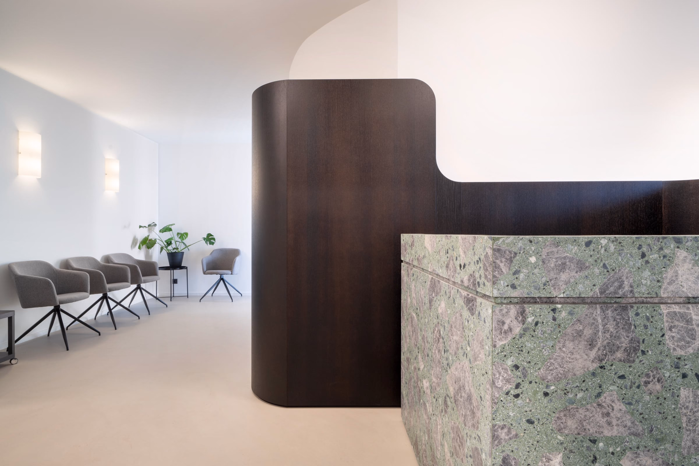 A room with a curved wall and a green counter