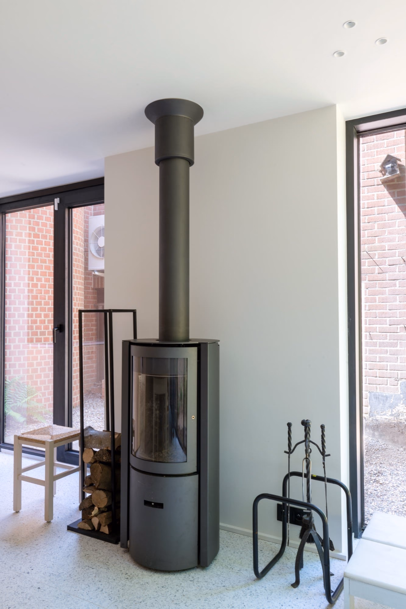A fireplace with a brick wall behind it