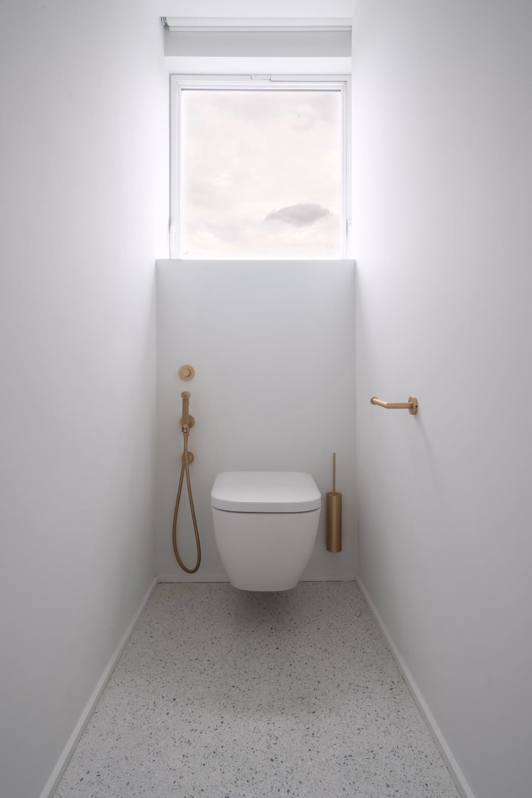 A small bathroom with a toilet and a window