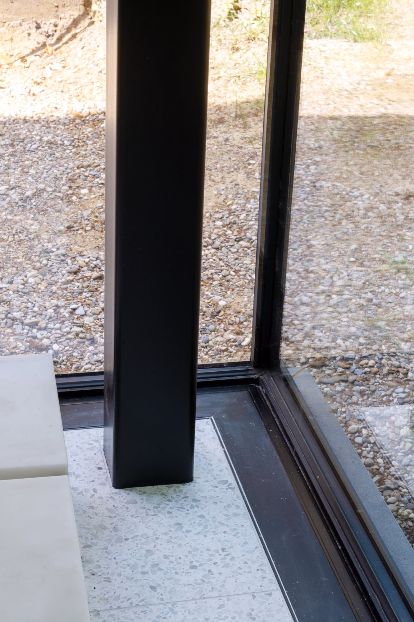 A black column in the corner of a window