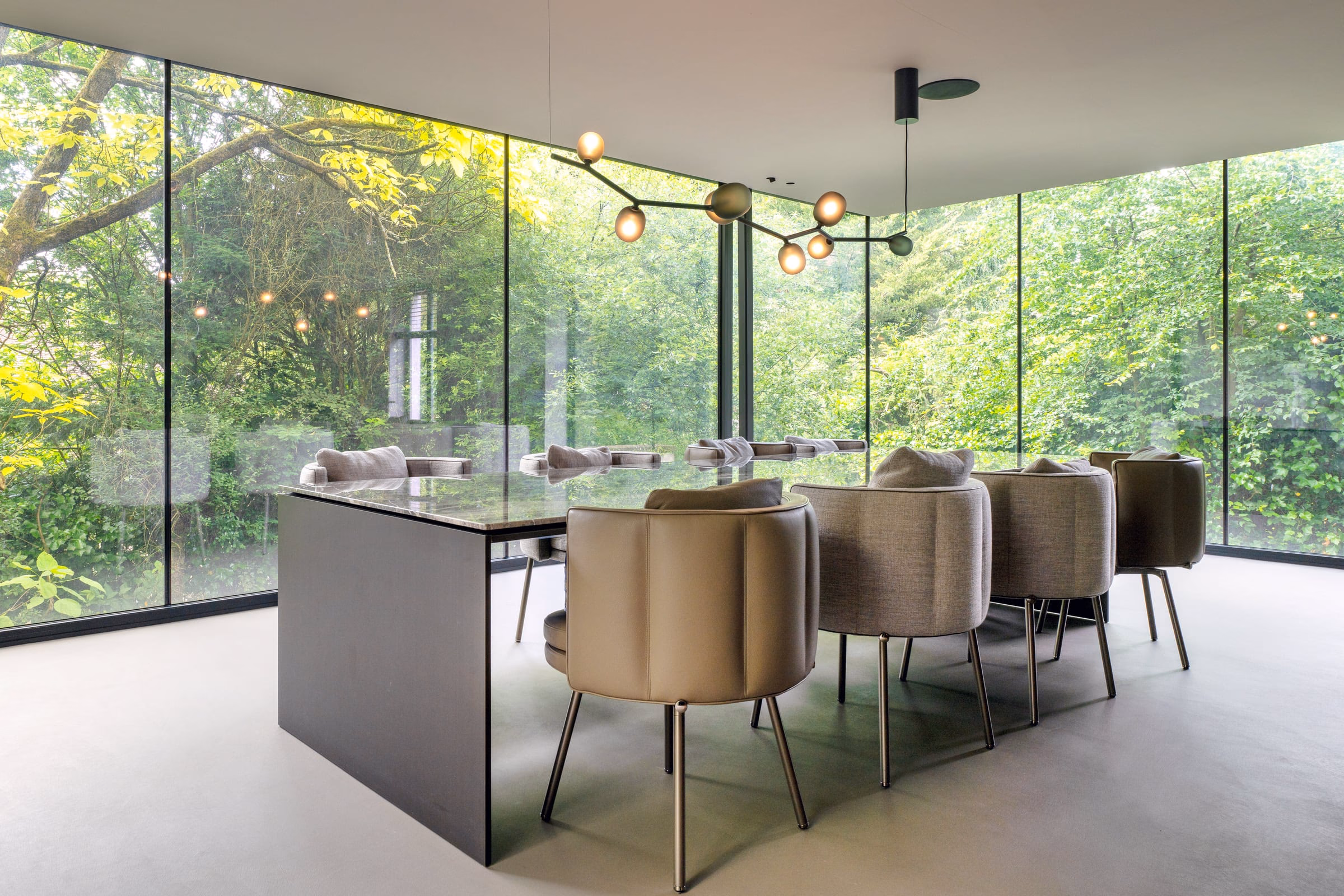 A dining room with a glass table and chairs