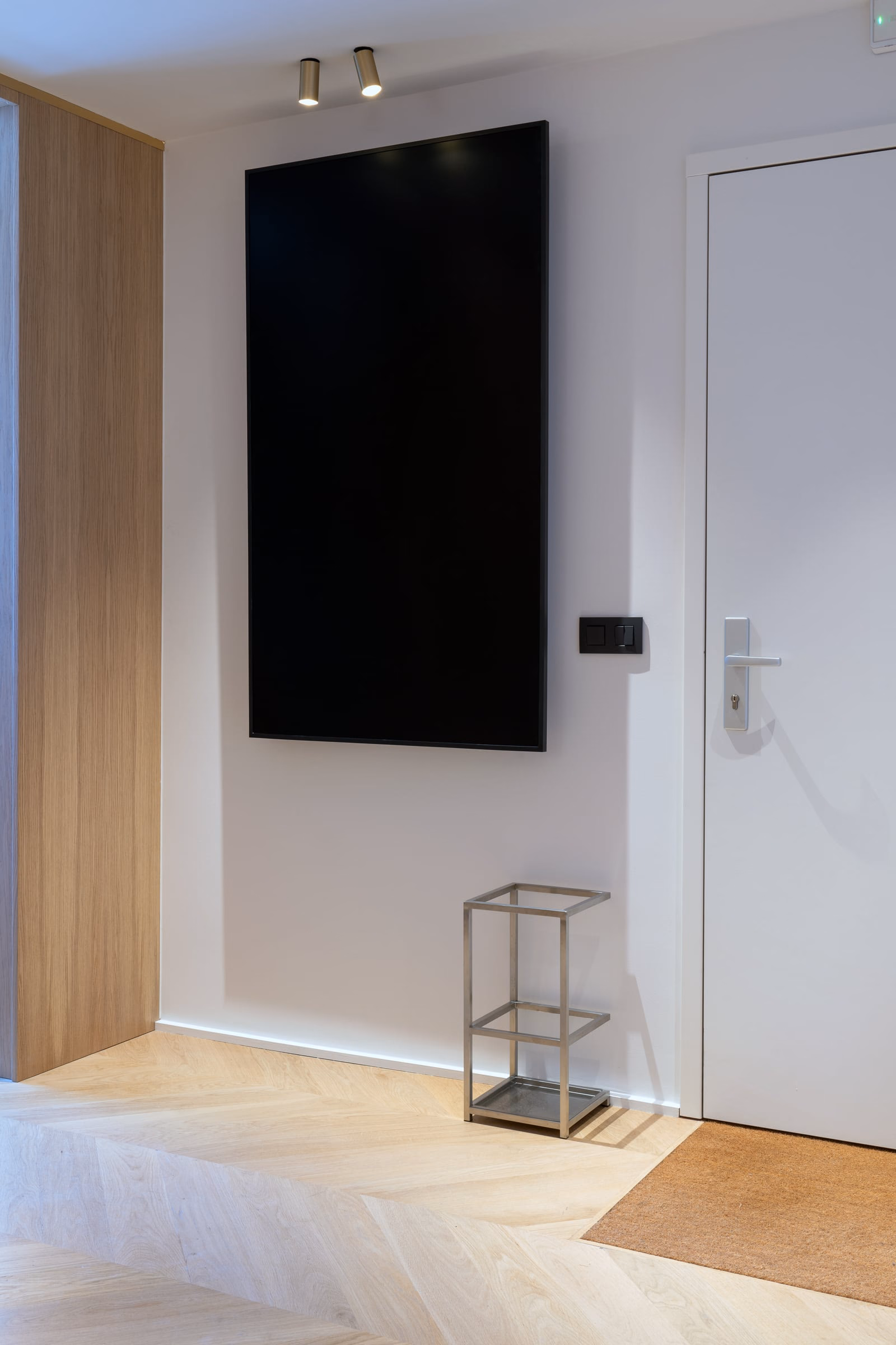 A black flat-screen television on a white wall