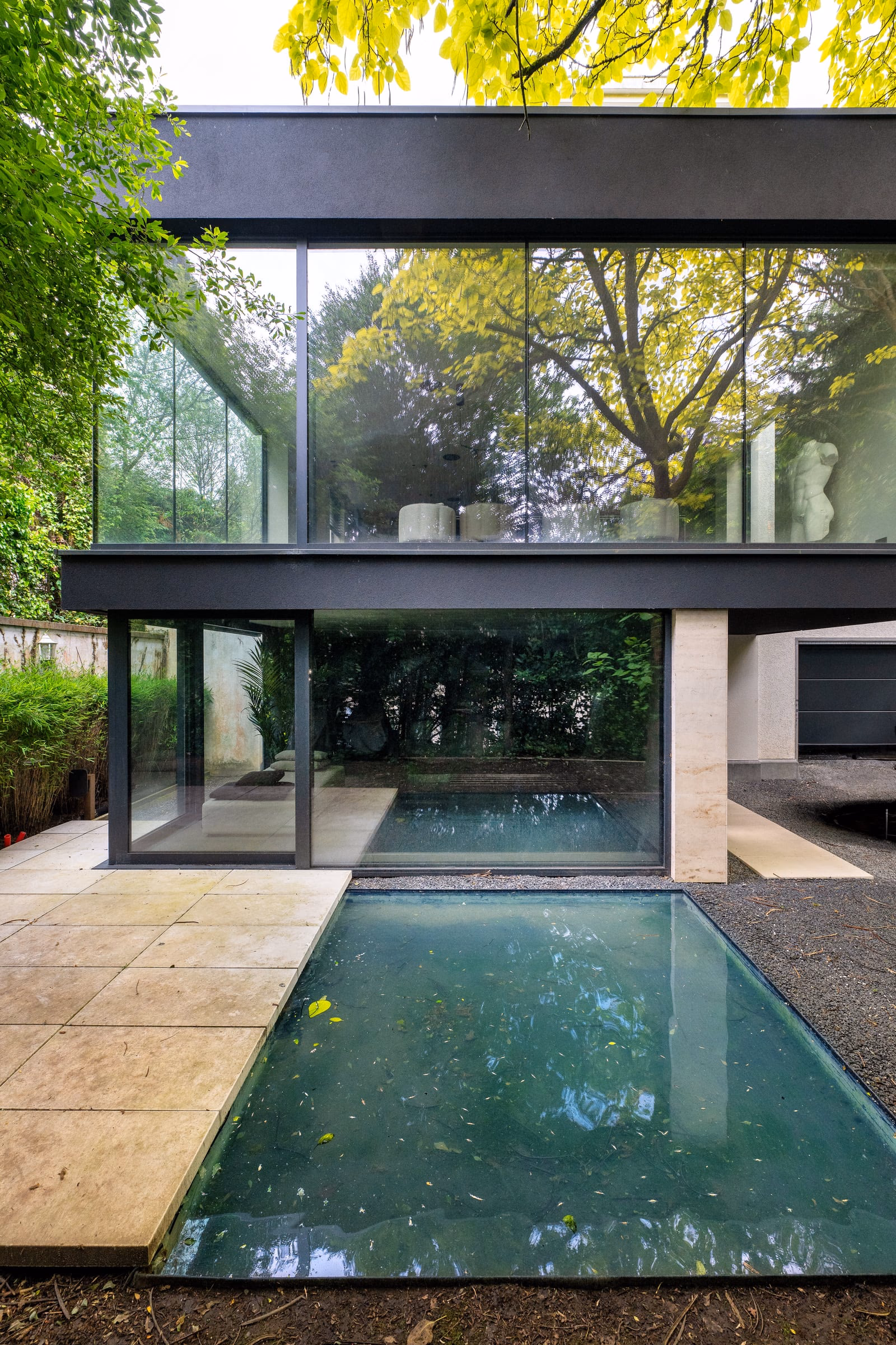 A large house with a swimming pool in front
