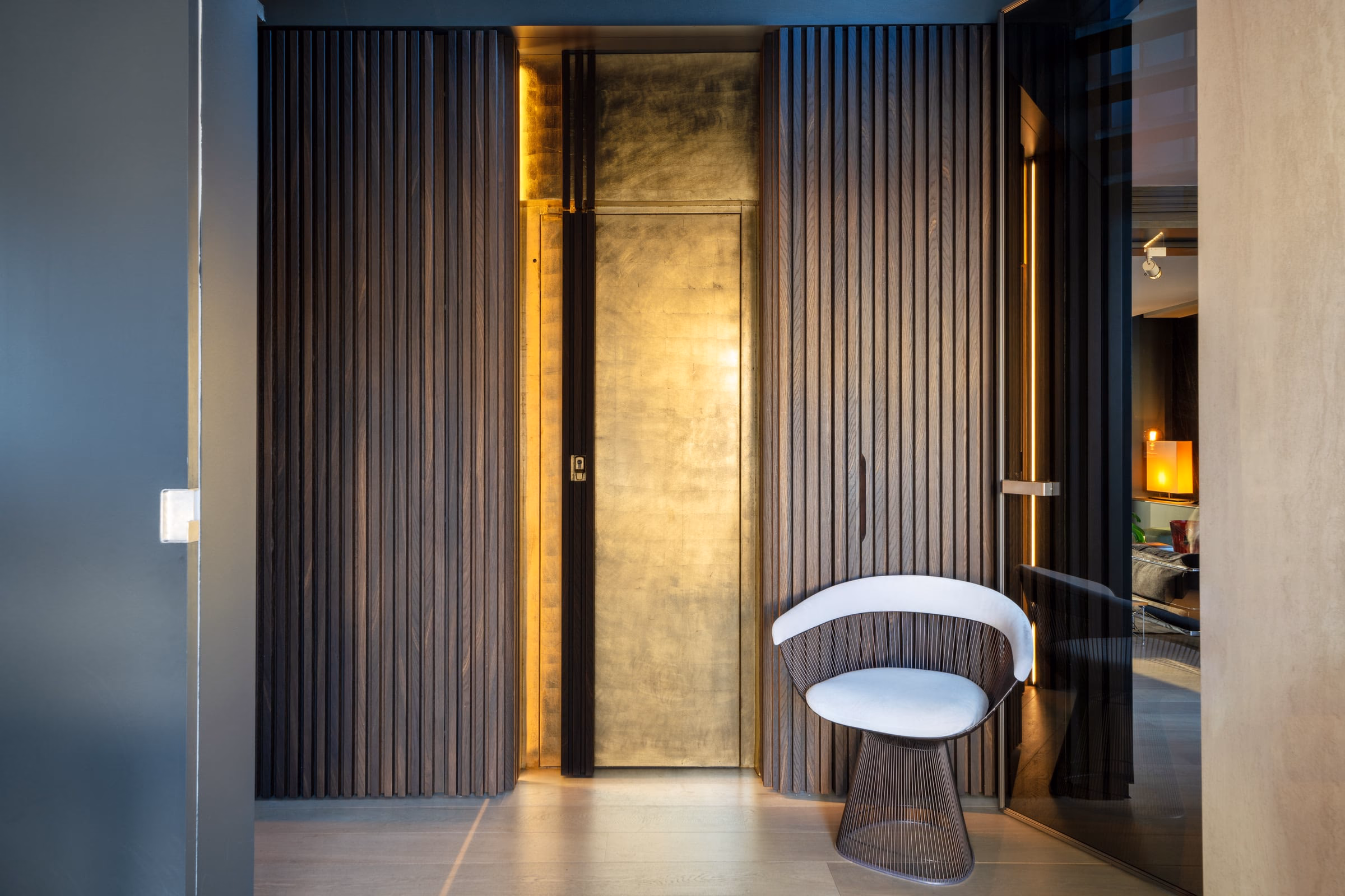 A chair in front of a door marked with the letter D